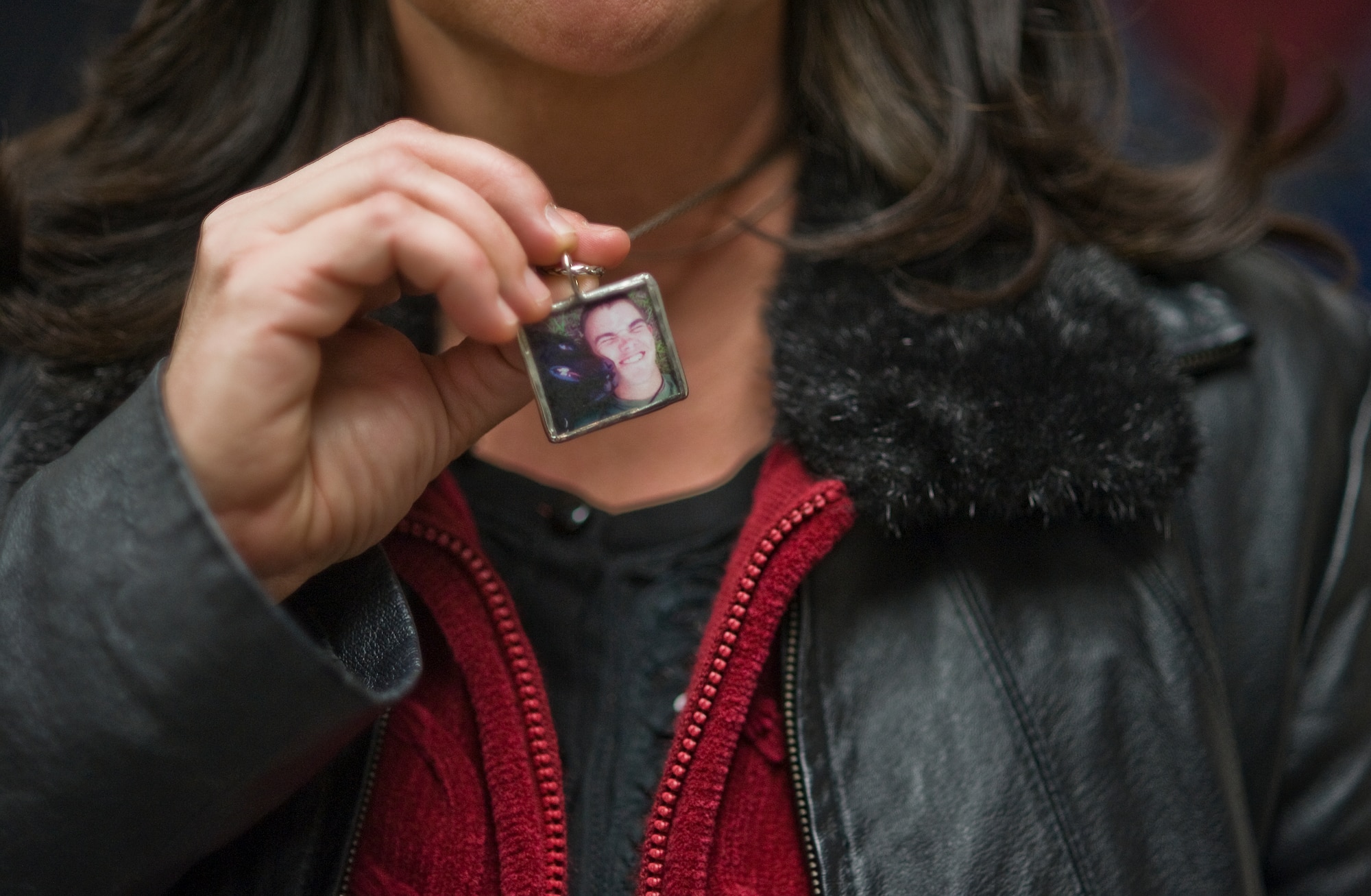 Kathy Rusk shows a pendant with a picture of her son, Marine Pfc. Colton Rusk and his military working dog Eli, a bomb-sniffing Labrador retriever. Private Rusk, 20, was killed Dec. 5 in Afghanistan by Taliban sniper fire.  Private Rusk’s family traveled to Lackland Air Force Base, Texas, Feb. 3, 2011, for a retirement and adoption ceremony.  Department of Defense officials granted the family permission to adopt Eli following his “retirement from the U.S. Marine Corps.” (U.S. Air Force photo/Tech. Sgt. Bennie J. Davis III)