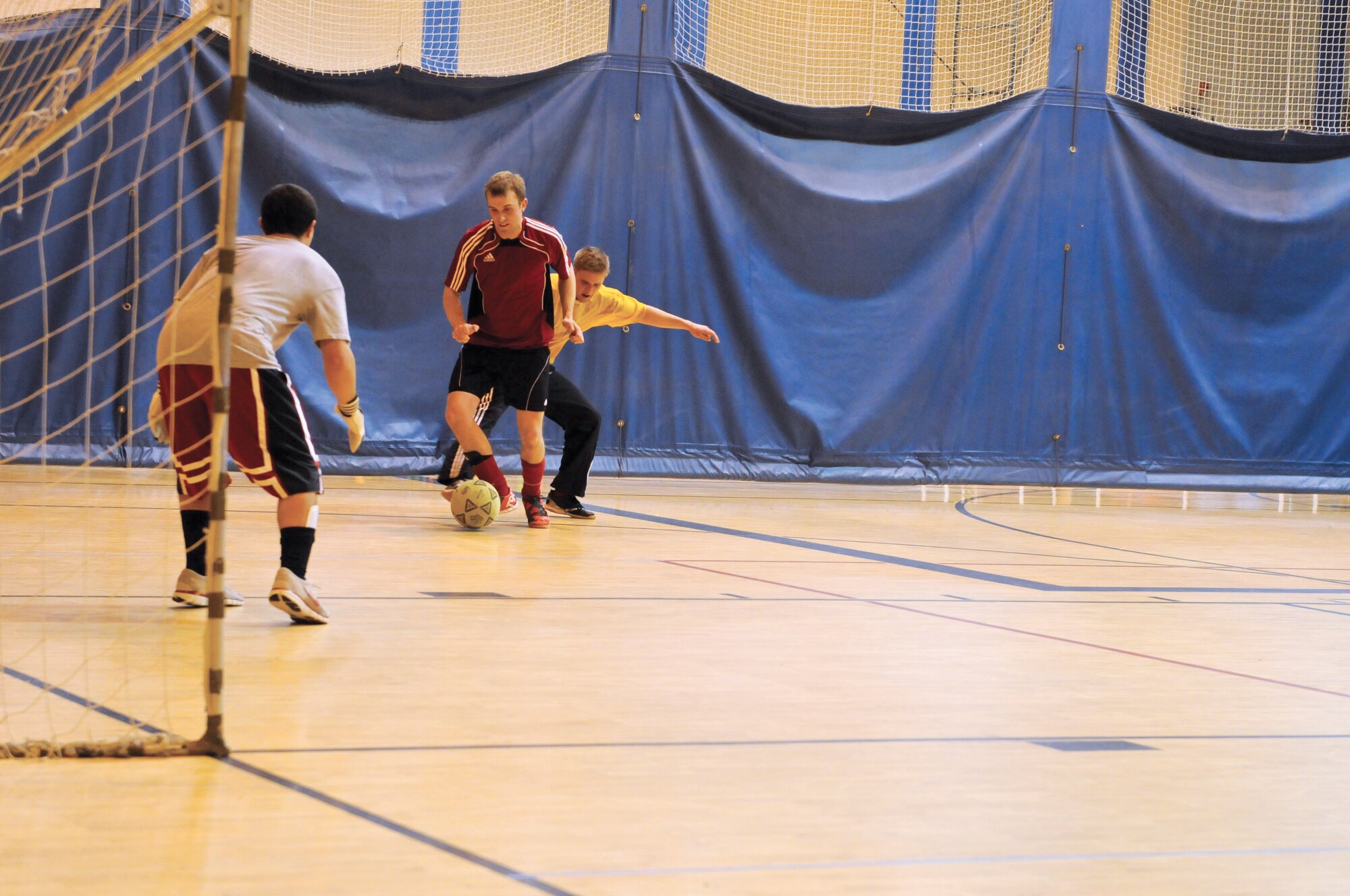 John McCollum, B/2-377th goalie, defends his goal against the advance of Blaine Hannan, 703rd AMXS. (U.S. Air Force photo/Steve White)