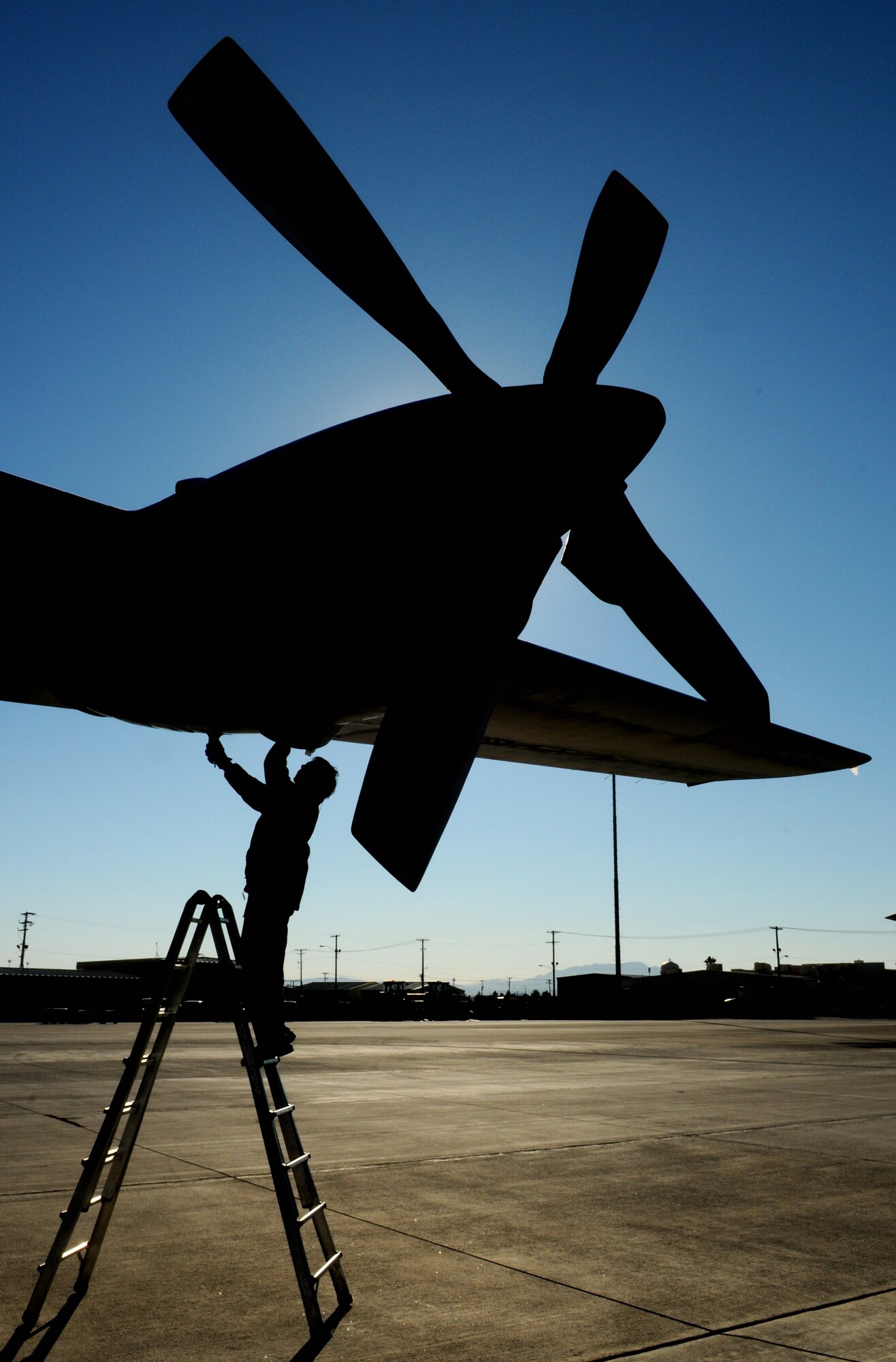 NELLIS AIR FORCE BASE, Nev. -- Adjutant Ludo Geens, aircraft maintainer, performs a post-flight inspection on a C-130 Hercules from the Belgium air force's 20 Squadron Feb. 2 after completing a mission in Red Flag 11-2. The C-130 and Adjutatn Geens are deployed from Melsbroek Air Base, Belgium, to participate in the combined exercise that provides a realistic combat training environment to the U.S. and its allies. (U.S. Air Force photo/Staff Sgt. Benjamin Wilson)