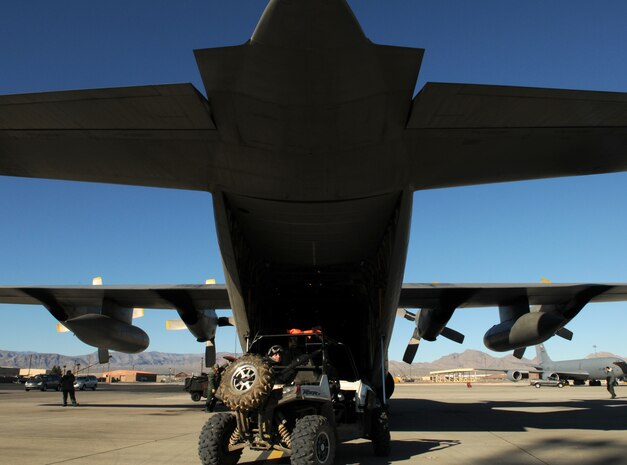 NELLIS AIR FORCE BASE, Nev. -- Staff Sgt. Brandon Pirmann, 414th Combat Training Squadron parachute rigger, drives an all-terrain vehicle from a C-130 Hercules from the Belgium air force's 20 Squadron Feb. 2 after completing a mission in Red Flag 11-2. The C-130 is deployed from Melsbroek Air Base, Belgium, to participate in the combined exercise that provides a realistic combat training environment to the U.S. and its allies. (U.S. Air Force photo/Staff Sgt. Benjamin Wilson)