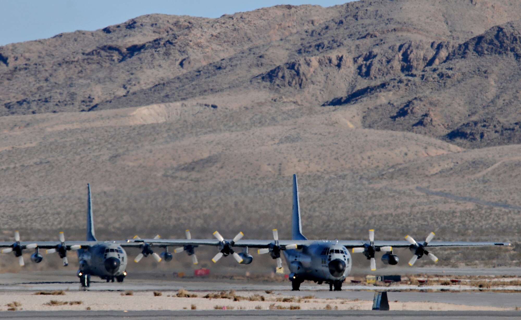 NELLIS AIR FORCE BASE, Nev. -- Two C-130 Hercules from the Belgium air force's 20 Squadron taxi on the flightline Feb. 2 after completing a mission in Red Flag 11-2. The C-130s deployed from Melsbroek Air Base, Belgium, to participate in the combined exercise that provides a realistic combat training environment to the U.S. and its allies. (U.S. Air Force photo/Staff Sgt. Benjamin Wilson)