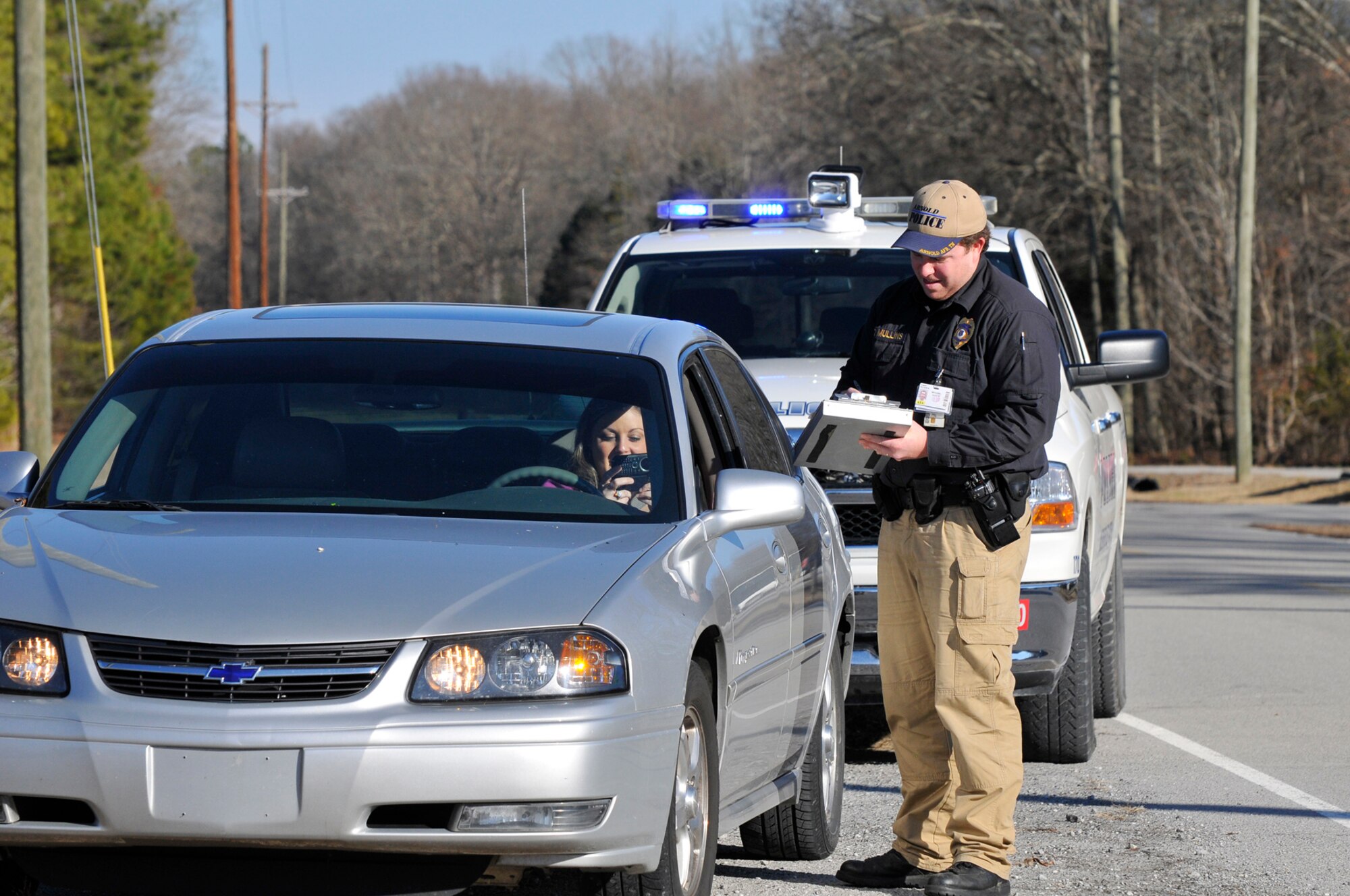 Patrol officers like Scott Mullins are constantly looking for drivers at AEDC who are paying more attention to their phones than the road. (Photo illustration by: Rick Goodfriend)