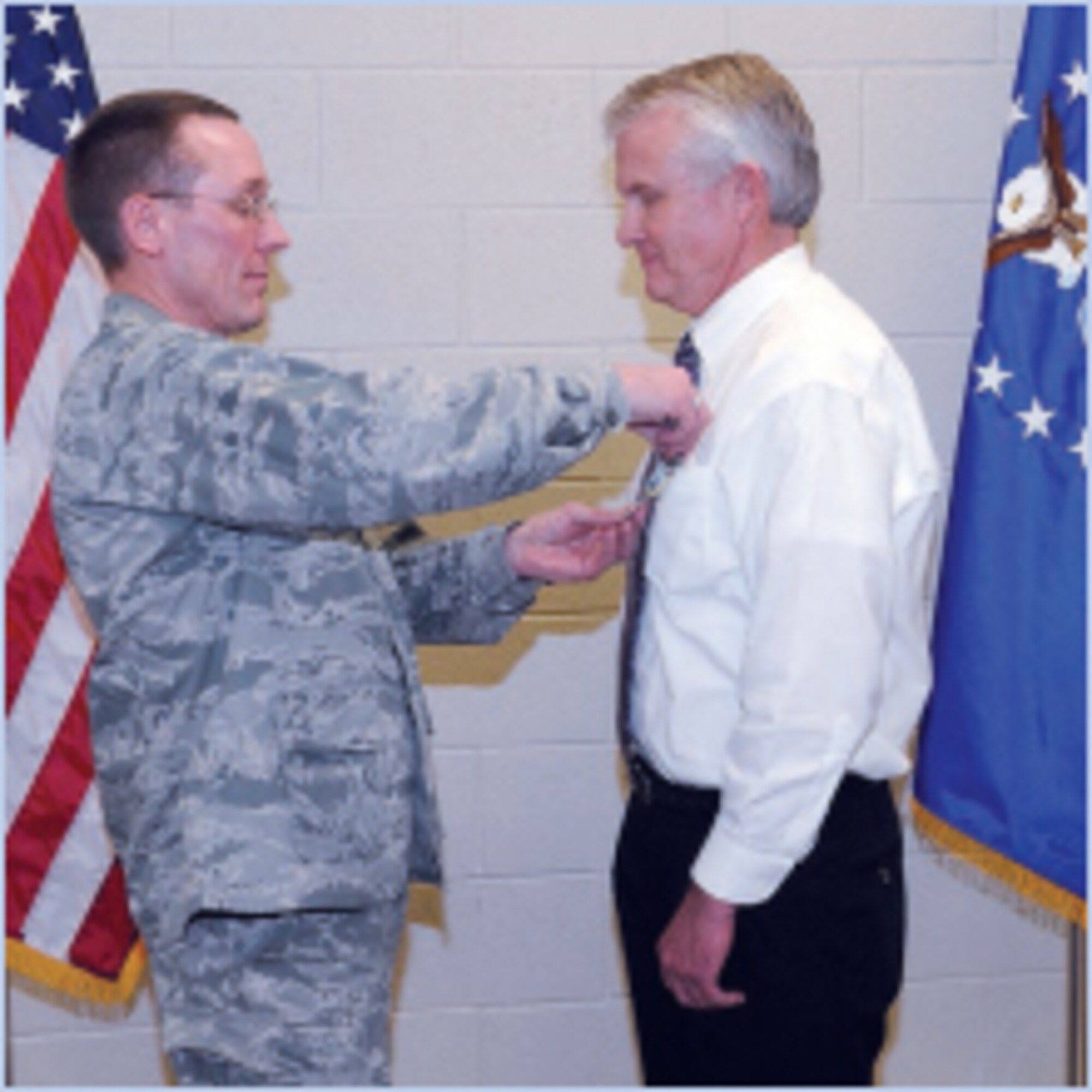 Col. Scott Stapp, Ogden Air Logistics Center Aerospace Sustainment Directorate commander, pins the Meritorous Civilian Service Award on Mark Bailey, chief, F-16 Modernization Flight, 501st Aircraft Sustainment Squadron, at a surprise award ceremony Jan. 19. (U.S. Air Force photo by Alex Lloyd