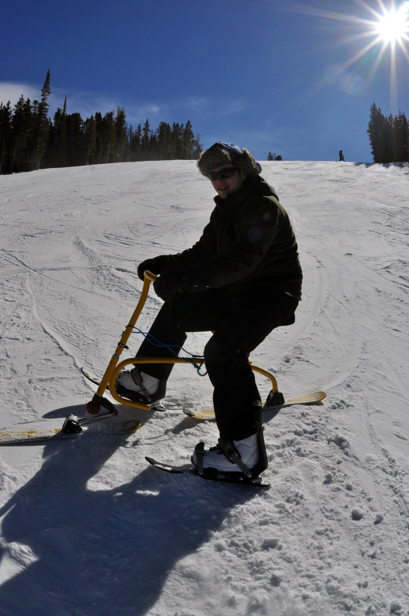 First Lt. Sean Howell, 90th OSS, finishes a run down the slope on a snowbike during SnoFest weekend. (U.S. Air Force photo by 1st Lt. Brooke Brzozowske)