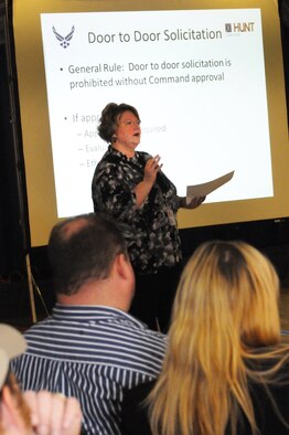 Kimberly Mlinaz of the Base Legal Office addresses attendees at the town hall meeting about door to door solicitation in the residential areas. U. S. Air Force photo by Sue Sapp 
