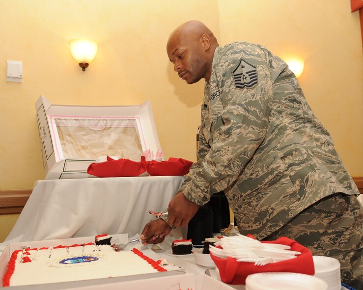 Master Sgt. Donnel Graham, 2nd Civil Engineer Squadron first sergeant, cuts a piece of cake at the 2nd Bomb Wing Quarterly Awards luncheon held at the Barksdale Club on Barksdale Air Force Base, La., Feb.3. The winners were nominated by their supervisors for their outstanding performance during the fourth quarter of 2010. (U.S. Air Force photo/Airman 1st Class Sean Martin)(Released)