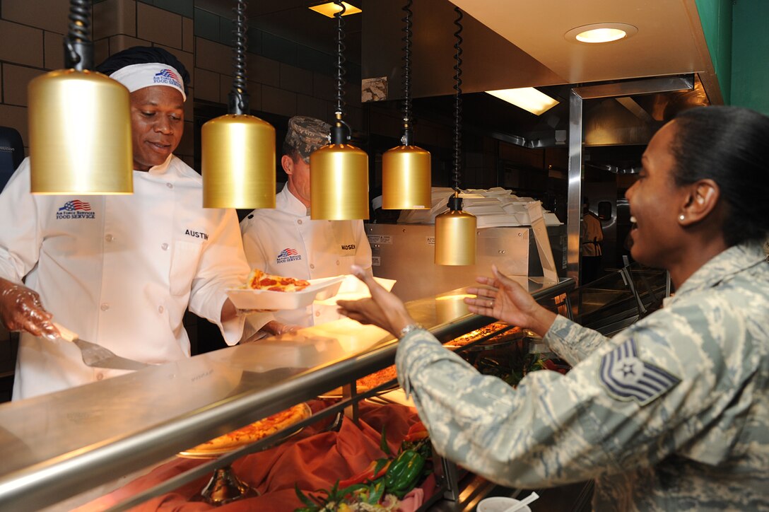 LANGLEY AIR FORCE BASE, Va. – Army Col. Reggie Austin, 633d Air Base Wing vice commander, serves pizza to Tech. Sgt. Shametra Lewis, 633d Force Support Squadron Airman Leadership School instructor, at the Crossbow Dining Facility Feb. 3. Each month, base commanders serve food to show their appreciation to the Airmen. (U.S. Air Force photo/Senior Airman Brian Ybarbo)