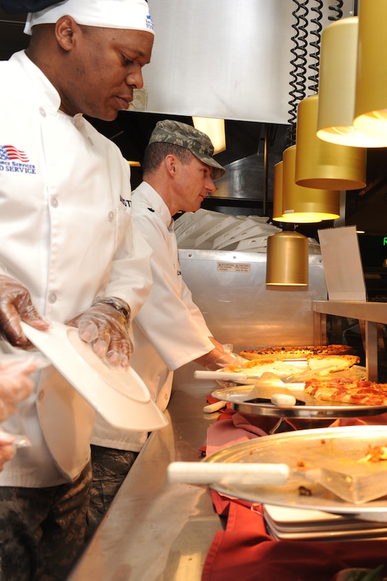 LANGLEY AIR FORCE BASE, Va. – Army Col. Reggie Austin, 633d Air Base Wing vice commander, and Lt. Col. Edward Madsen, 633d Logistics Readiness Squadron commander, serves pizza to Airman Feb. 3. Each month, base commanders serve to show their appreciation to the Airmen. (U.S. Air Force photo/Senior Airman Brian Ybarbo)