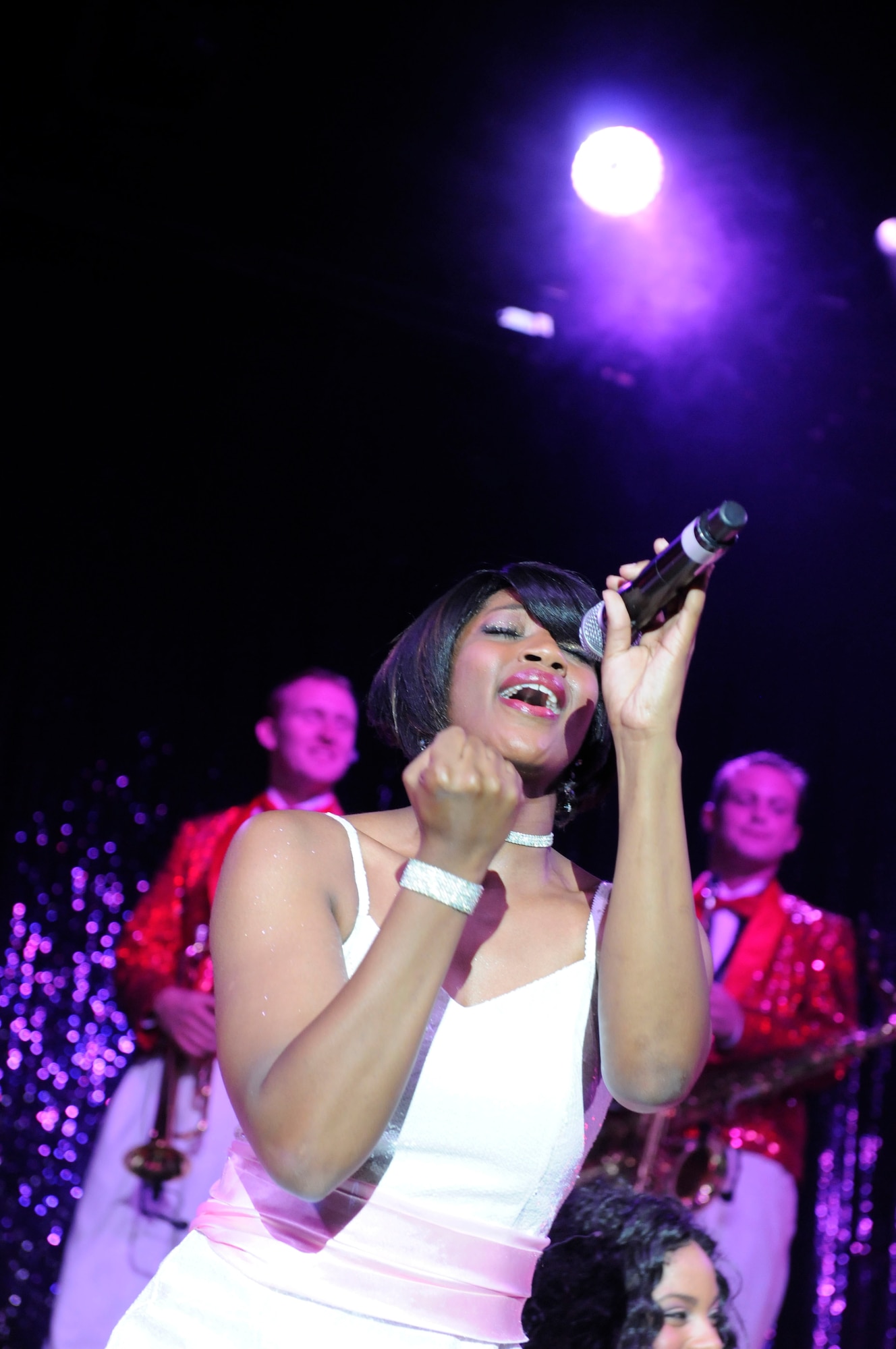 Senior Airman Monique-Robertson, a performer with Air Force Tops in Blue, belts out lyrics during a Saturday performance at Talkeetna Theater. (U.S. Air Force photo/Steve White)