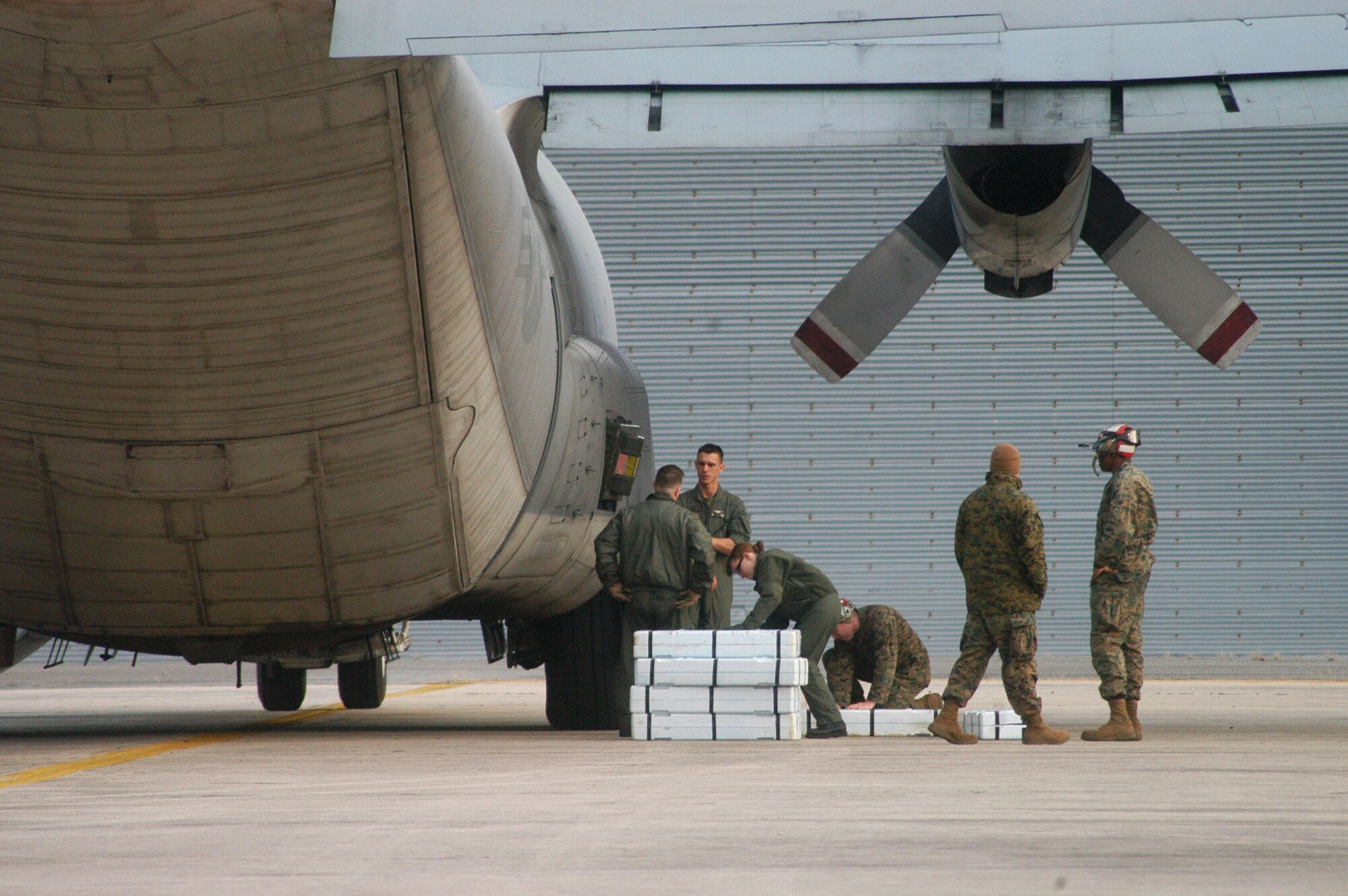 Marines unload ordnance to be used in their exercise from a C-130 on Robins flightline this week. U. S. Air Force photo by Sue Sapp
