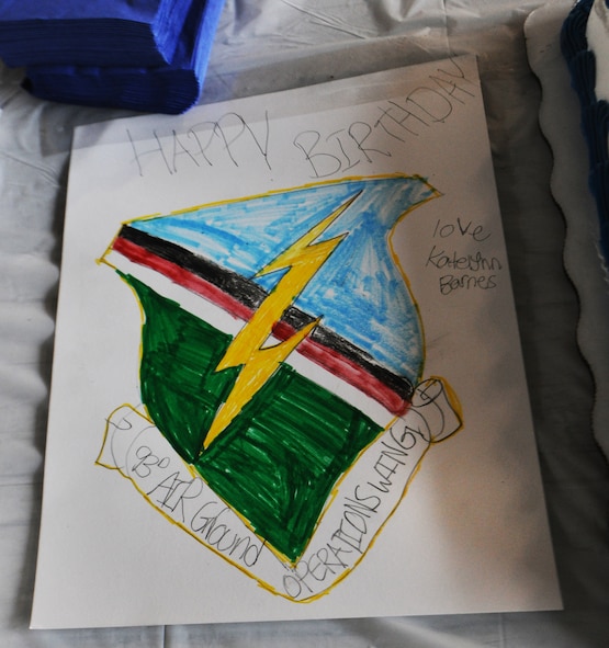 MOODY AIR FORCE BASE, Ga.-- A birthday card sits beside a cake at the 93rd Air Ground Operations Wing’s third birthday celebration Feb. 1. Katelynn Barnes, daughter  of Steve Barnes and the late Master Sgt. Norma Barnes, who passed away in August 2009, created the card for the 93rd AGOW  in memory of her mother who was stationed with the wing as the NCO in charge of personnel. (U.S. Air Force photo/Airman 1st Class Benjamin Wiseman)(RELEASED)