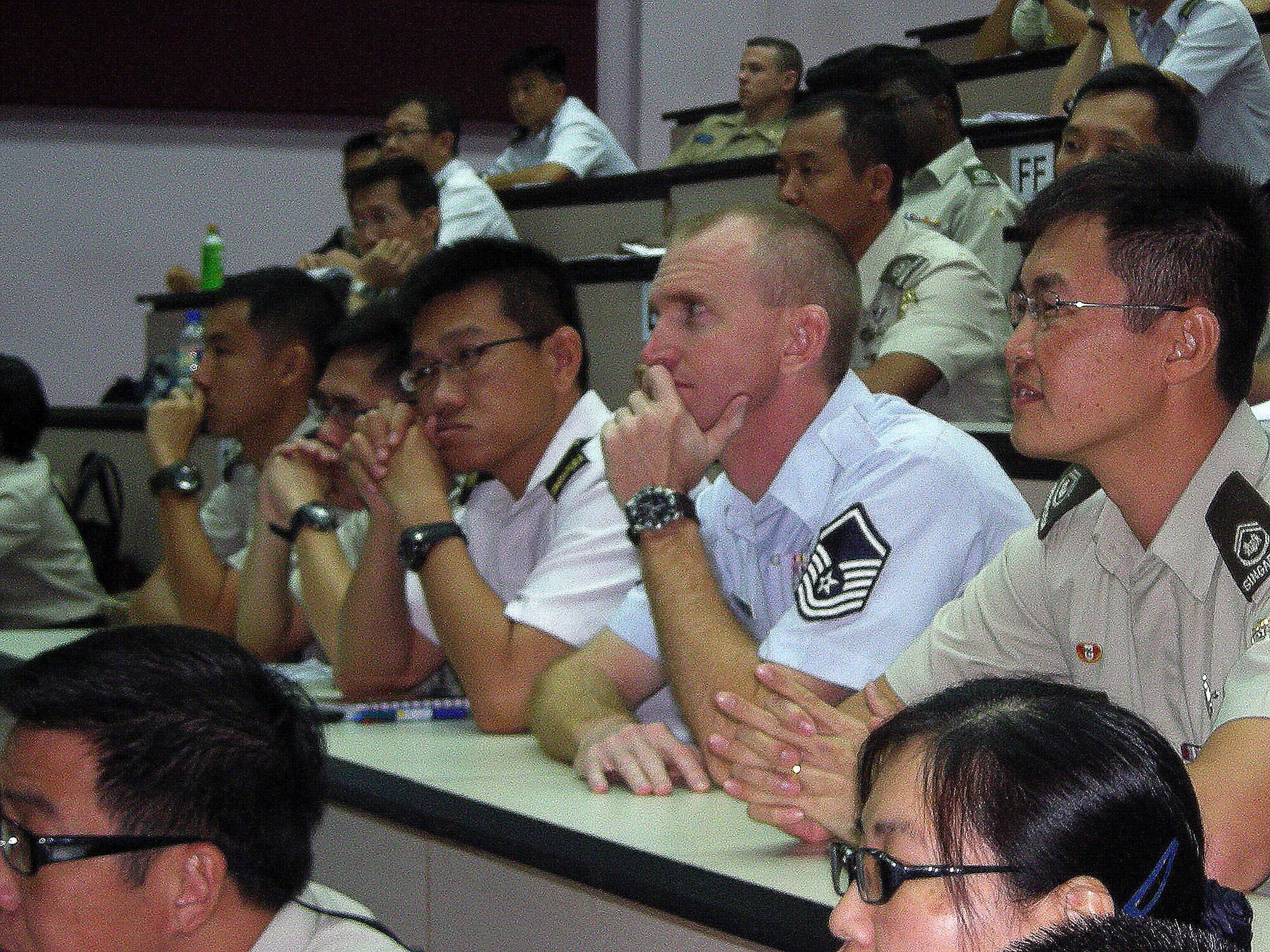 Master Sgt. David Sawyer attends the Advanced Leadership Program with
Singapore airmen Jan. 15, 2011, at Pasir Laba Camp, Republic of Singapore.
The program included 75 Singapore airmen and four international students and
focused on communication, leadership, management, and mentoring and
evaluation tactics. (Courtesy Photo)  
