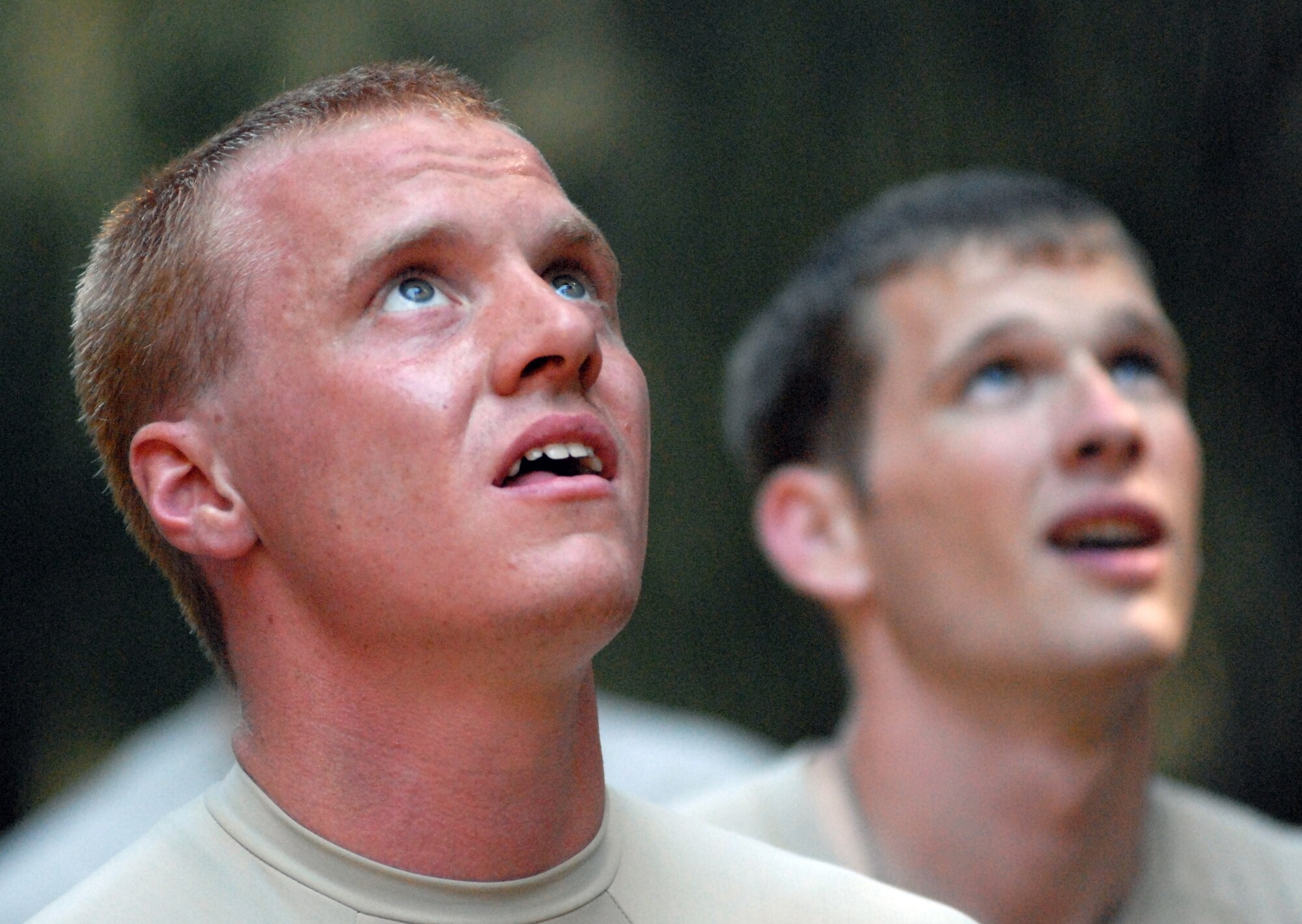 Senior Airmen Ray Burk and Jordan Miller, 647th Security Forces Squadron Airmen from Joint Base Pearl Harbor-Hickam, Hawaii, watch as their fellow Airmen complete an obstacle course owned by Schofield Barracks in Wahiawa, Hawaii, during try-outs for the Army Air Assault Course Feb. 1, 2011. A total of 16 security forces members are scheduled to attend the two-week Air Assault Course beginning May 5, 2011. These try-outs will help the Air Force security forces NCO in charge of training determine which Airmen he will send to this challenging course. (U.S. Air Force photo/Staff Sgt. Carolyn Viss)