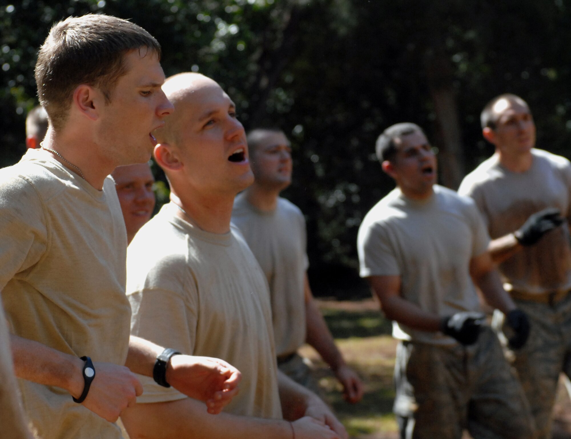 Airmen from the 647th Security Forces Squadron Airmen at Joint Base Pearl Harbor-Hickam, Hawaii, cheer on their fellow Airmen as they complete an obstacle course in Wahiawa, Hawaii, Feb. 1, 2011. A total of 16 security forces members are scheduled to attend a two-week Air Assault Course beginning May 5, 2011. These February try-outs will help the Air Force security forces NCO in charge of training determine which Airmen he will send to this challenging course. (U.S. Air Force photo/Staff Sgt. Carolyn Viss)