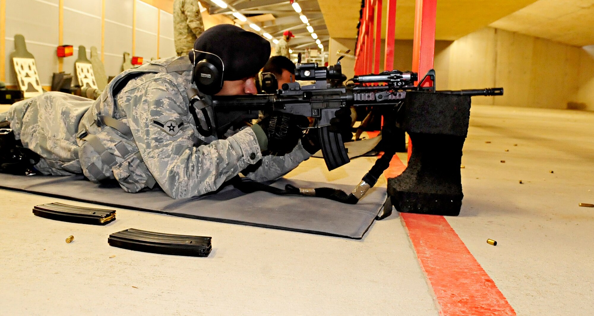 RAF FELTWELL, England -- Airman Nelson Williamson, 100th Security Forces Squadron security response patrolman, takes aim downrange while in the prone position during a weapons qualification course for RAF Mildenhall security forces members here Feb. 3, 2011. All Security forces members are required to score 18 shots out of 30 to qualify and 25 out of 30 to achieve marksman. (U.S. Air Force photo/Senior Airman Ethan Morgan)