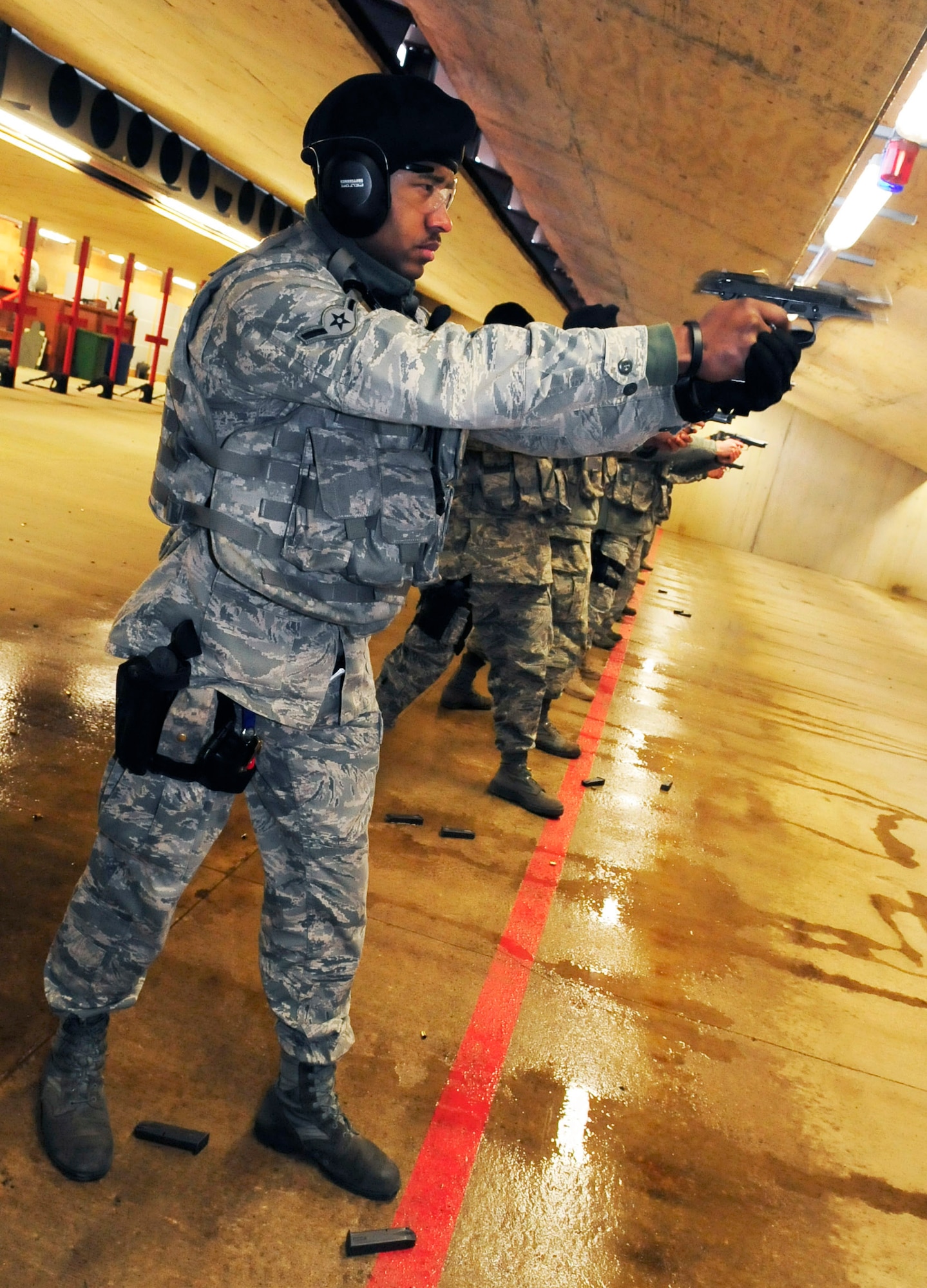 RAF FELTWELL, England -- Airman Nelson Williamson, 100th Security Forces Squadron security response patrolman, qualifies on an M-9 pistol during a weapons qualification course for RAF Mildenhall security forces members Feb. 3, 2011, at the newly reopened firing range here. Security forces members must qualify on the M-9 along with the M-4 carbine annually. (U.S. Air Force photo/Senior Airman Ethan Morgan)