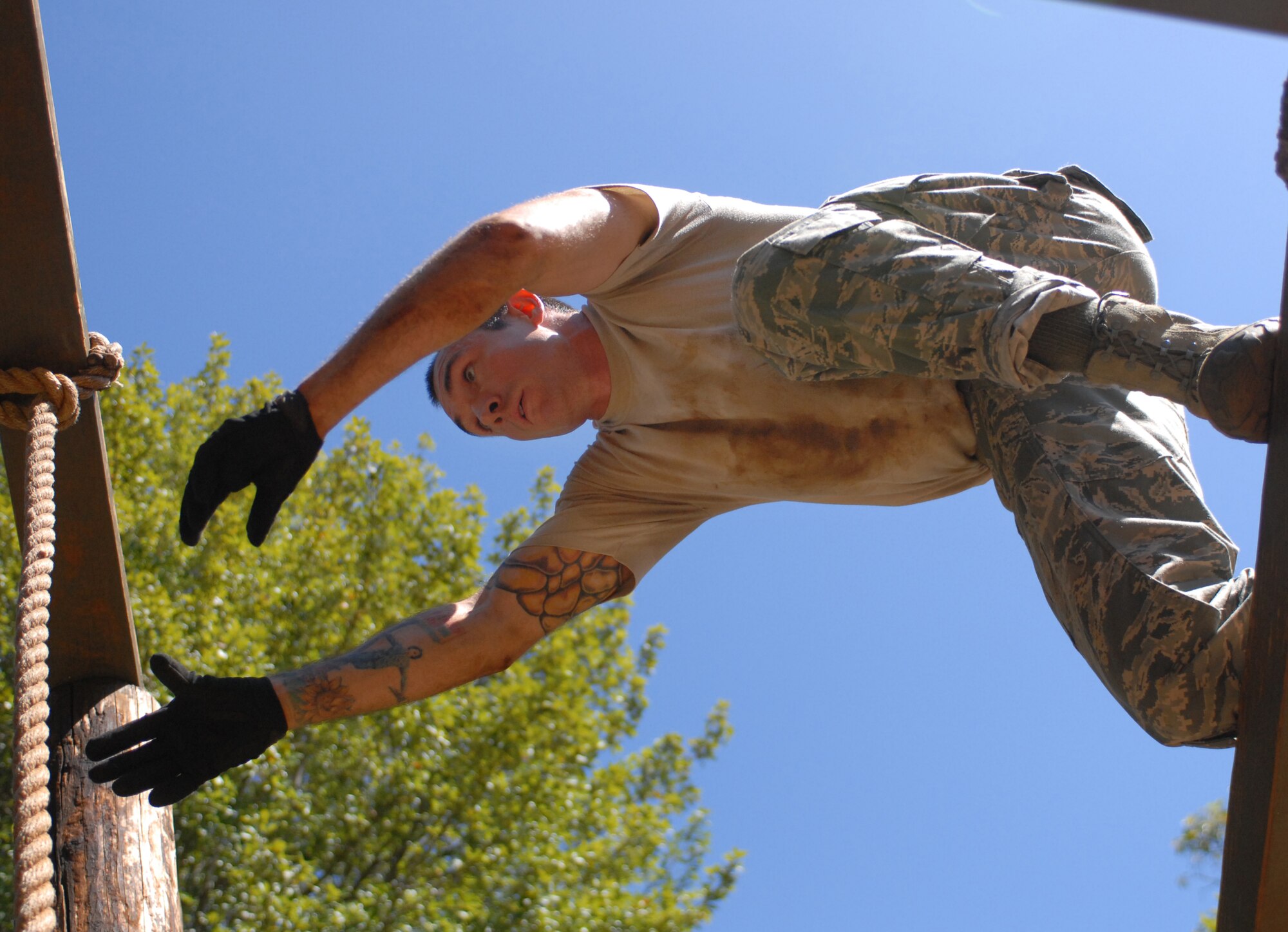 Staff Sgt. Shawn Cecere, a 647th Security Forces Squadron Airman from Joint Base Pearl Harbor-Hickam, Hawaii, leaps to grab a rope on an obstacle course Feb. 1, 2011, in Wahiawa, Hawaii. He and 11 other Airmen were trying out for a two-week Army Air Assault Course beginning May 5, 2011. These try-outs will help the Air Force security forces NCO in charge of training determine which Airmen he will send to this challenging course. (U.S. Air Force photo/Staff Sgt. Carolyn Viss)