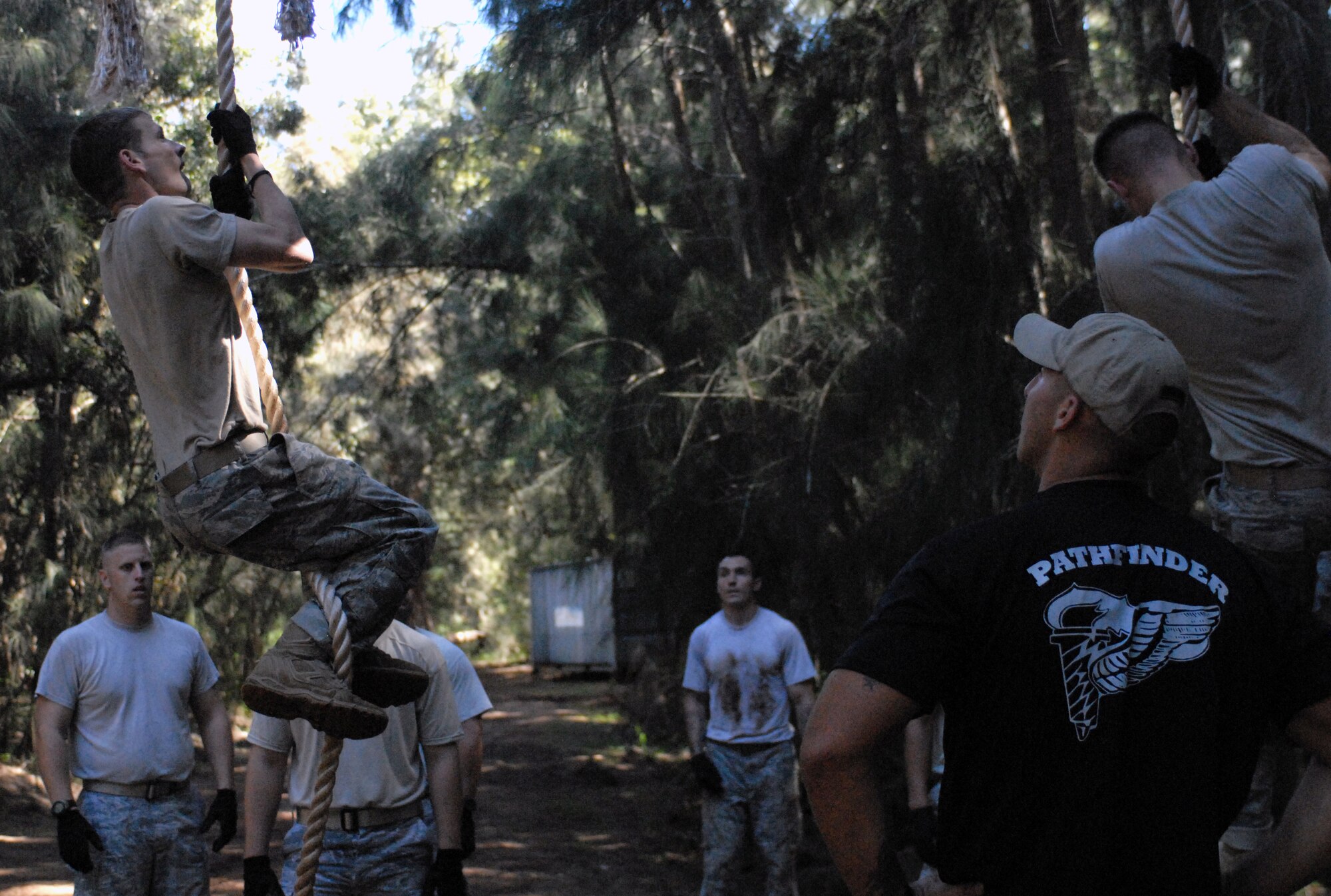 Staff Sgt. Brett Lafreniere, the 647th Security Forces Squadron NCO in charge of training at Joint Base Pearl Harbor-Hickam, Hawaii, watches as Airmen practice climbing ropes on an obstacle course in Wahiawa, Hawaii, Feb. 1, 2011. A total of 16 security forces members are scheduled to attend a two-week Army Air Assault Course beginning May 5, 2011. These try-outs will help Sergeant Lafreniere determine which Airmen he will send to this challenging course. (U.S. Air Force photo/Staff Sgt. Carolyn Viss)