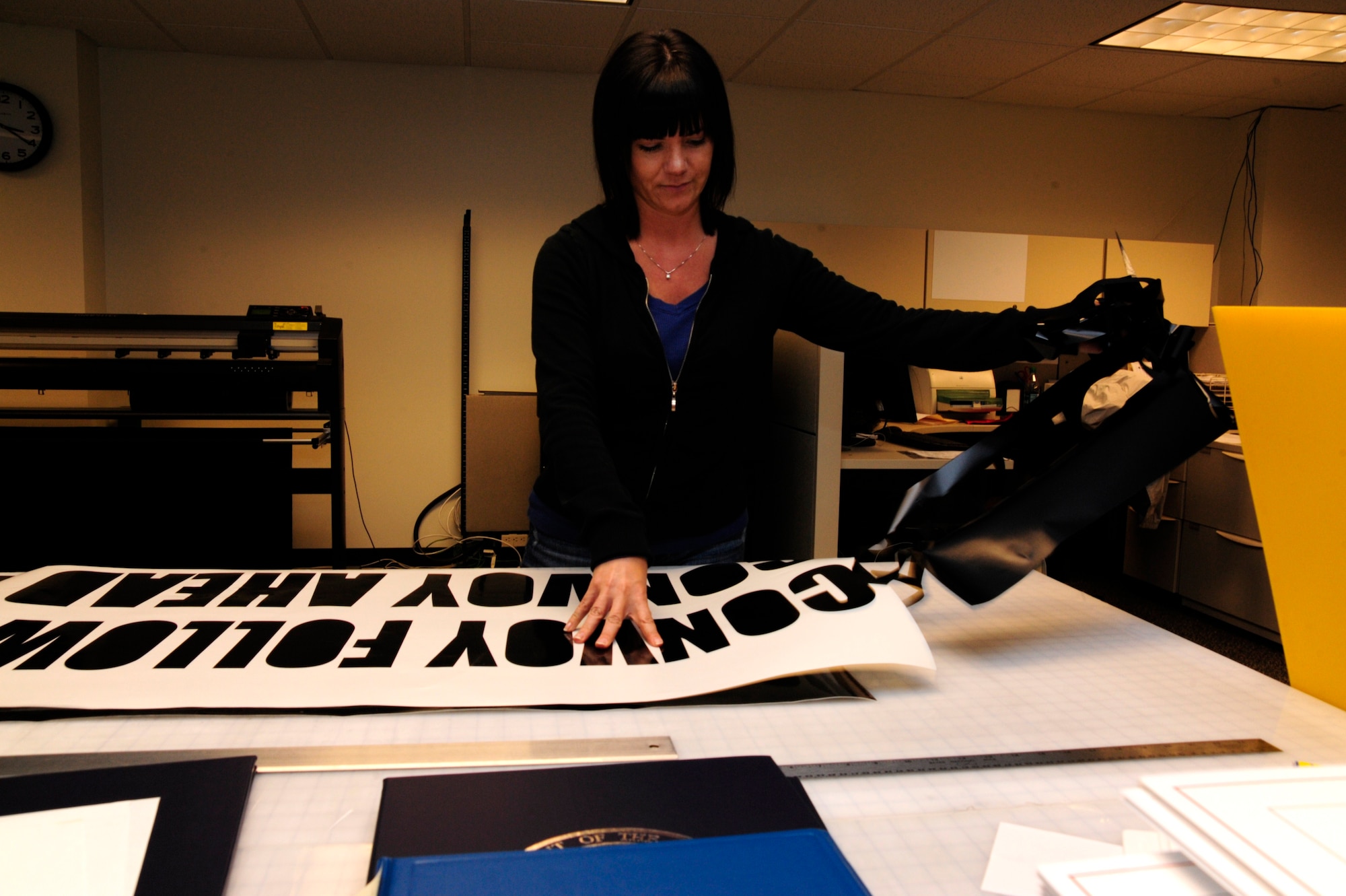 Melanie Williams, 627th ABG Visual Information Services Center specialist, makes a sign Jan. 31 at Joint Base Lewis-McChord, Wash. (U.S. Air Force photo/Master Sgt. Chris Haylett)