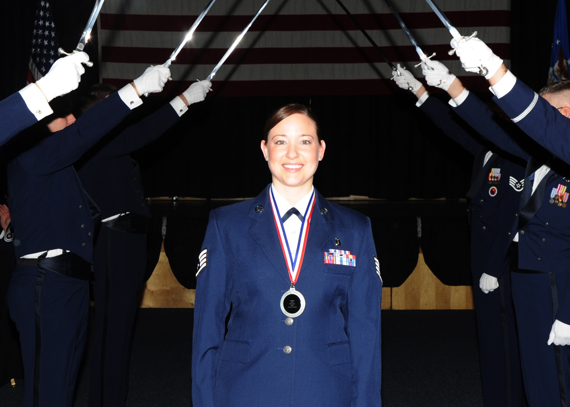 Staff Sergeant Bethany Sterling, 22nd Aerospace Medicine Squadron Community Health NCOIC, walks through the sabers as part of the annual awards ceremony held in the Robert J. Dole Community Center ballroom, Jan. 28, 2011, McConnell Air Force Base, Kan.  Sergeant Sterling is McConnell’s 2010 Noncommissioned Officer of the Year. (U.S. Air Force photo/Airman 1st Class Katrina M. Brisbin)