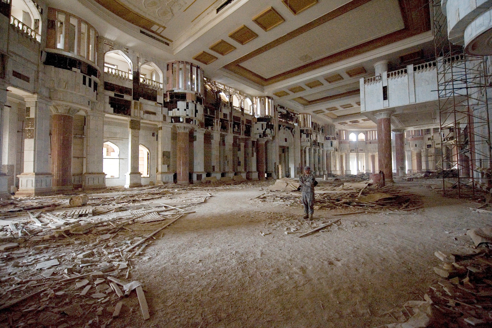 A lone tour guide stands in a ballroom waiting for tour patrons to catch up the main tour group Jan. 29, 2011, at the Victory Over America Palace in Baghdad, Iraq. The Sather Air Base Chapel runs tours of historic sites on a regular basis, but time is running out as U.S. forces return portions of Victory Base Complex back to Iraqi military forces. (U.S. Air Force photo/Staff Sgt. Levi Riendeau) 