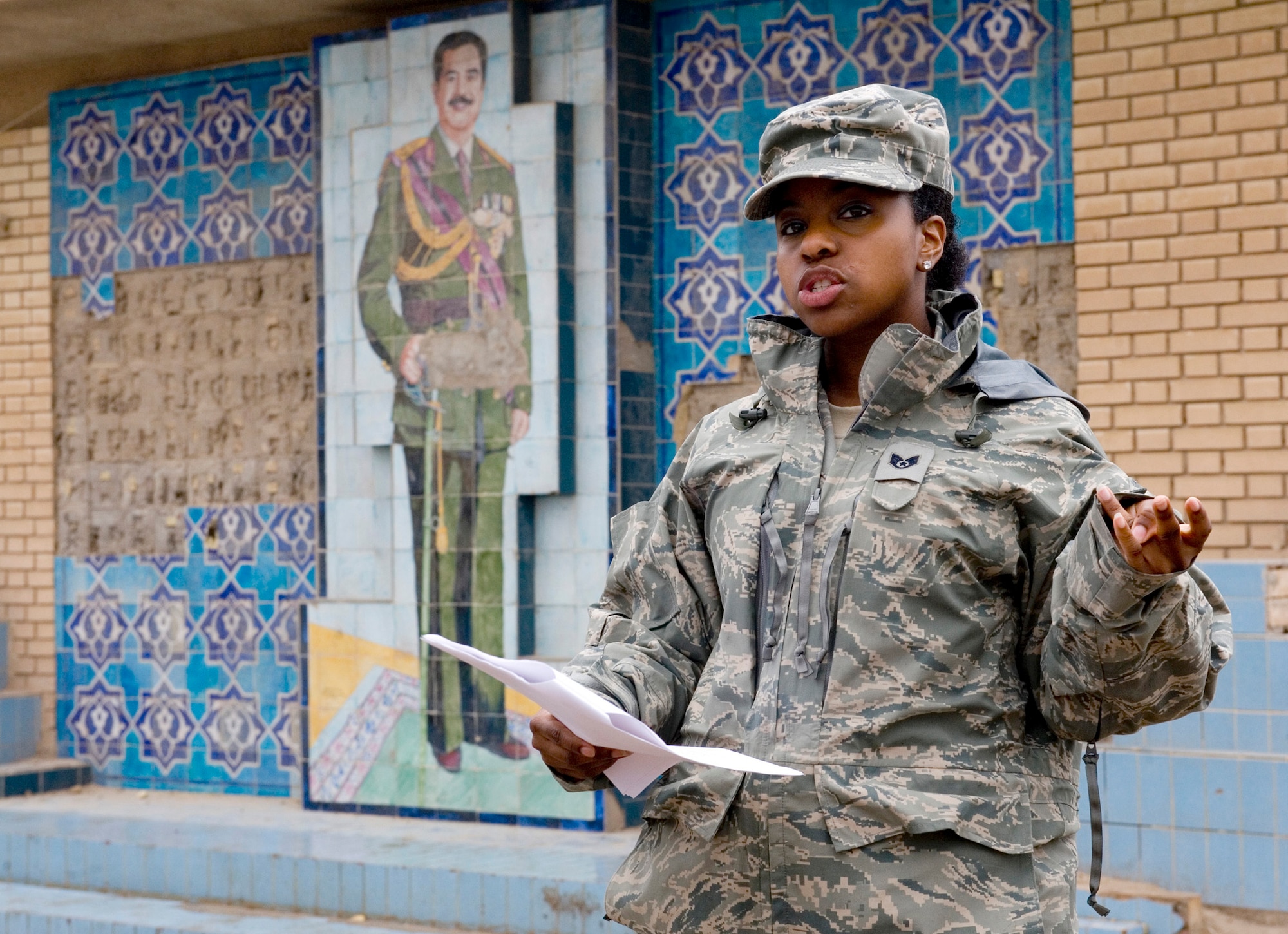 Staff Sgt. Angela Ward talks about Saddam Hussein during a tour of historic buildings Jan. 29, 2011, in Baghdad, Iraq. The Sather Air Base Chapel runs tours of historic sites on a regular basis. Sergeant Ward is a 447th Air Expeditionary Group chaplain?s assistant. (U.S. Air Force photo/Staff Sgt. Levi Riendeau) 