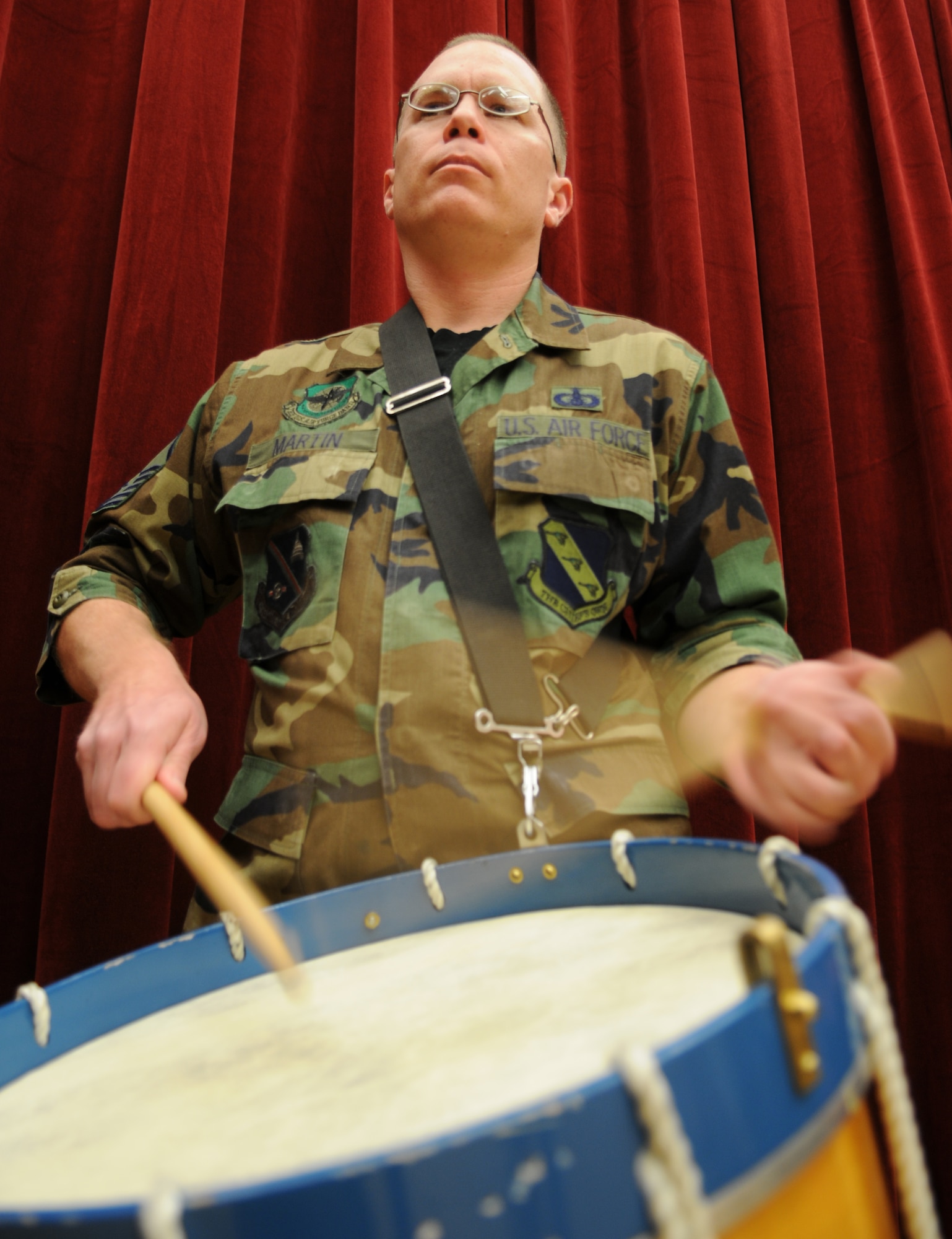 U.S. Air Force Band Ceremonial Bandsman Master Sgt. Christopher Martin, pictured here in hangar two on Joint Base Anacostia-Bolling, Washington D.C., demonstrates the revolutionary war era drum that will be used to provide marching cadence for the Joint Color Guard during opening ceremonies for Super Bowl XLV in Dallas, Texas Sunday, Feb. 6. Sergeant Martin will travel to Dallas with another Air Force drummer and a color team Airman from The U.S. Air Force Honor Guard. (U.S. Air Force photo illustration by Senior Airman Christopher Ruano)