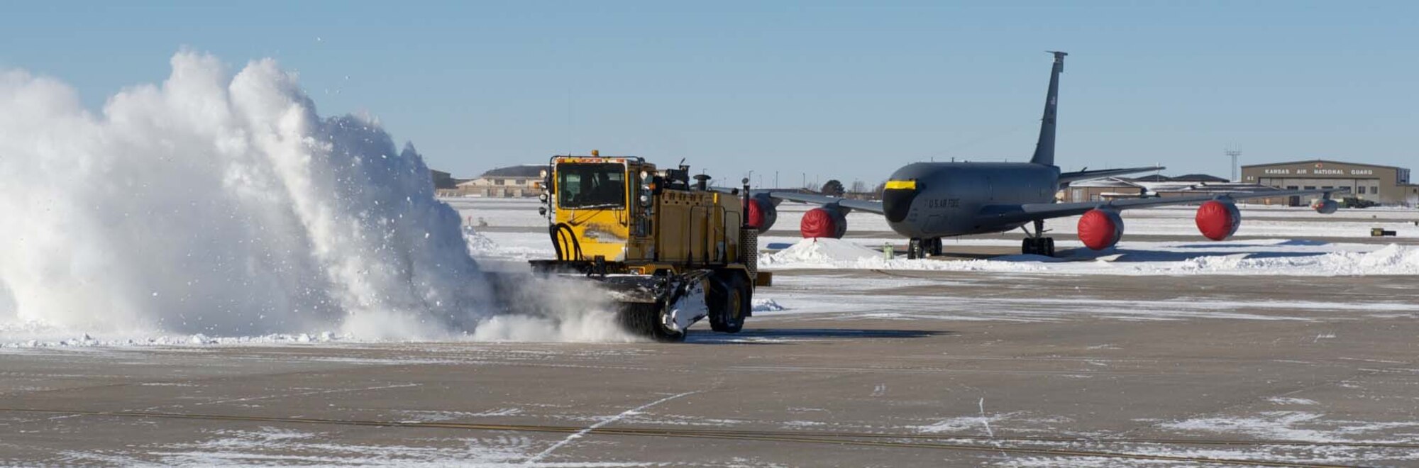 Members of the 22nd Civil Engineer Squadron plow through the remnants of a massive blizzard on the flightline Feb. 2, 2011, McConnell Air Force Base, Kan.  Dozens of motorists in and around Wichita, Kan., found themselves stuck in the snow. (U.S. Air Force photo/Staff Sgt. Michael Schocker)