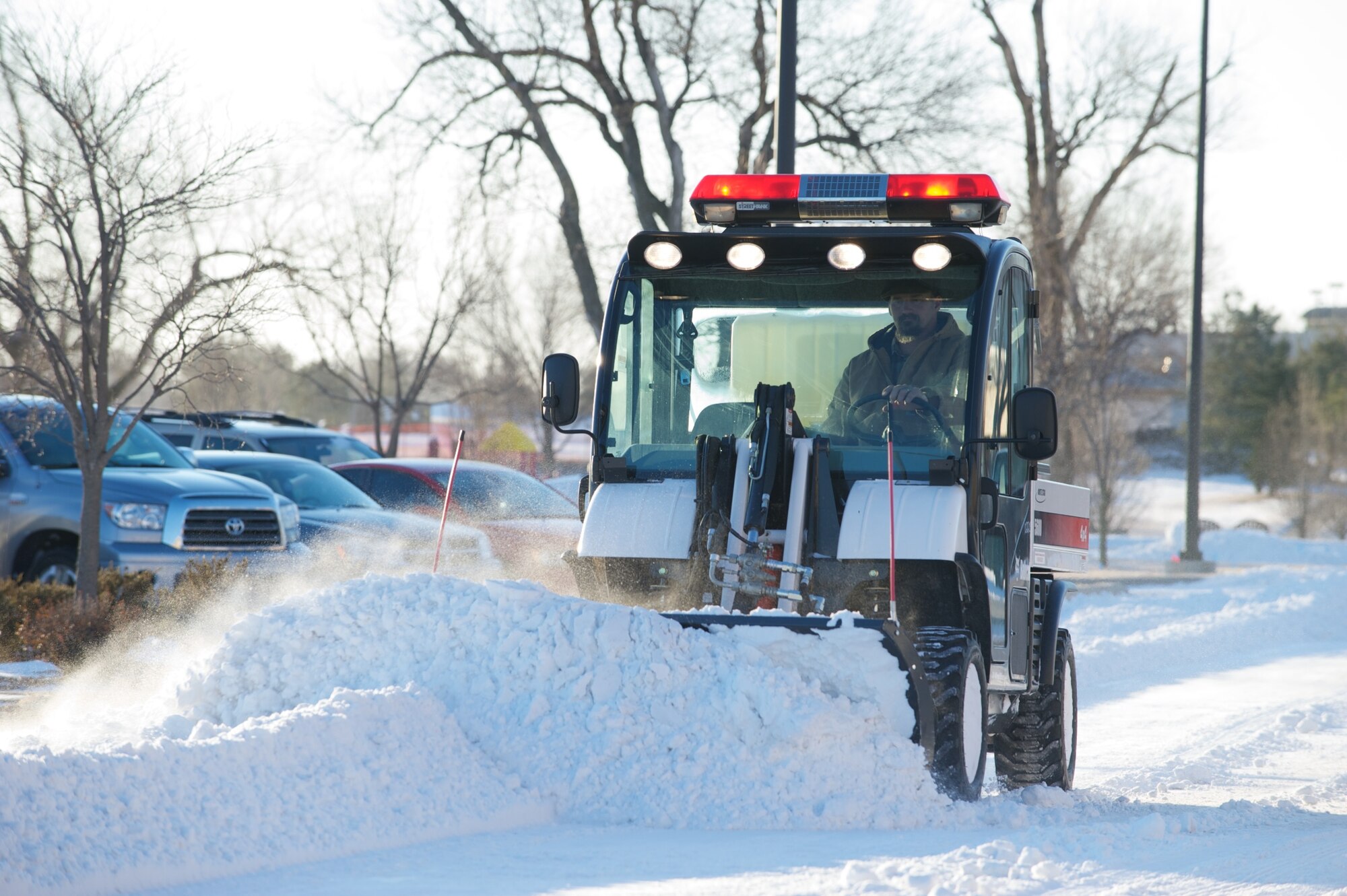 Clay Sattler, 22nd Civil Engineer Squadron Entomology member, plows through snow on Kansas Street Feb. 2, 2011, McConnell Air Force Base, Kan.  The snow was the result of a massive winter storm that stretched across more than 2,000 miles from Texas to New England.  (U.S. Air Force photo/Staff Sgt. Michael Shocker)