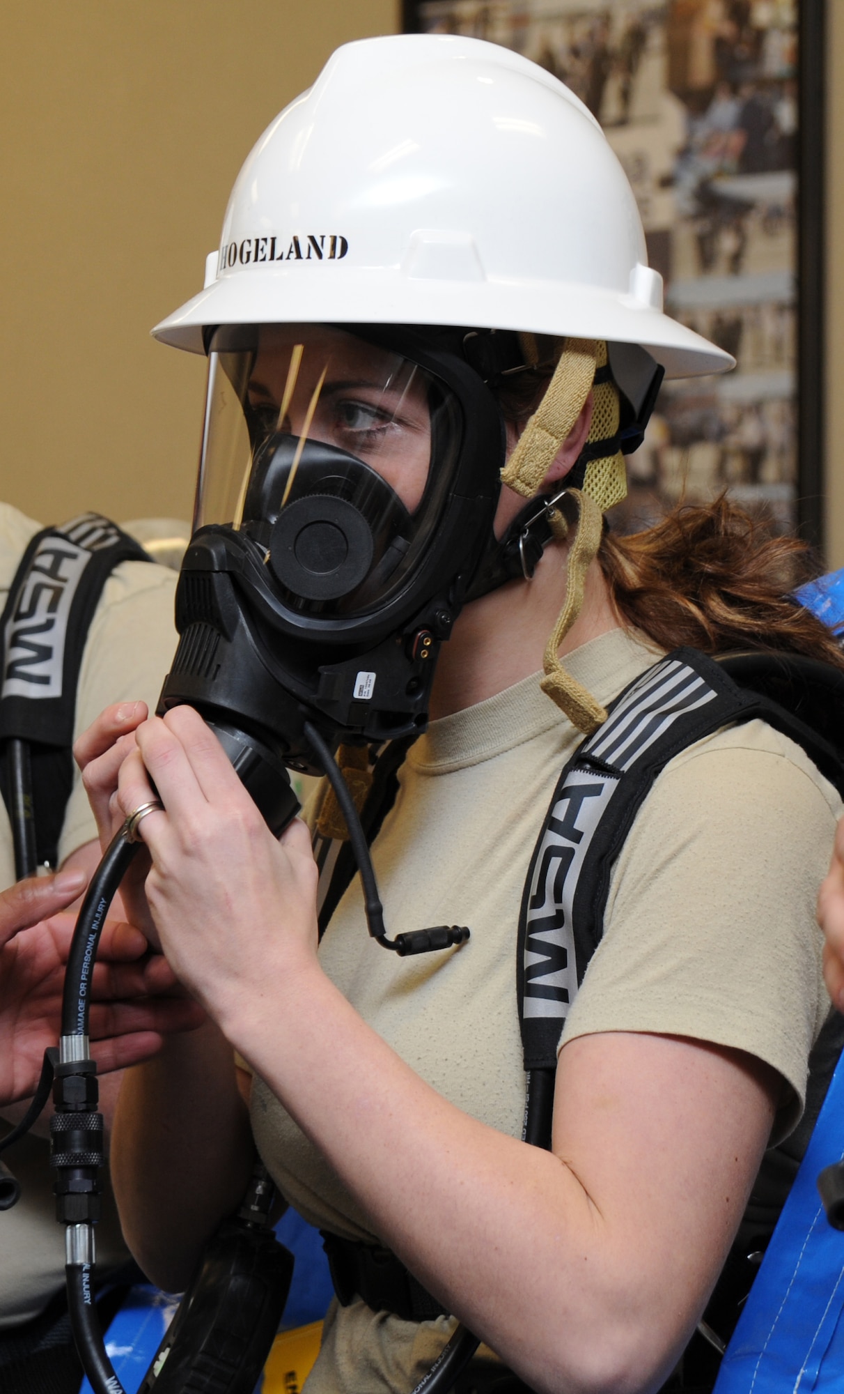 Senior Airman Tiffany Hogeland, 118th AW Civil Engineering, checks the fit of her oxygen mask before suiting up to test an unknown substance during the all hazard response training at Berry Field Air National Guard Base Jan. 26.