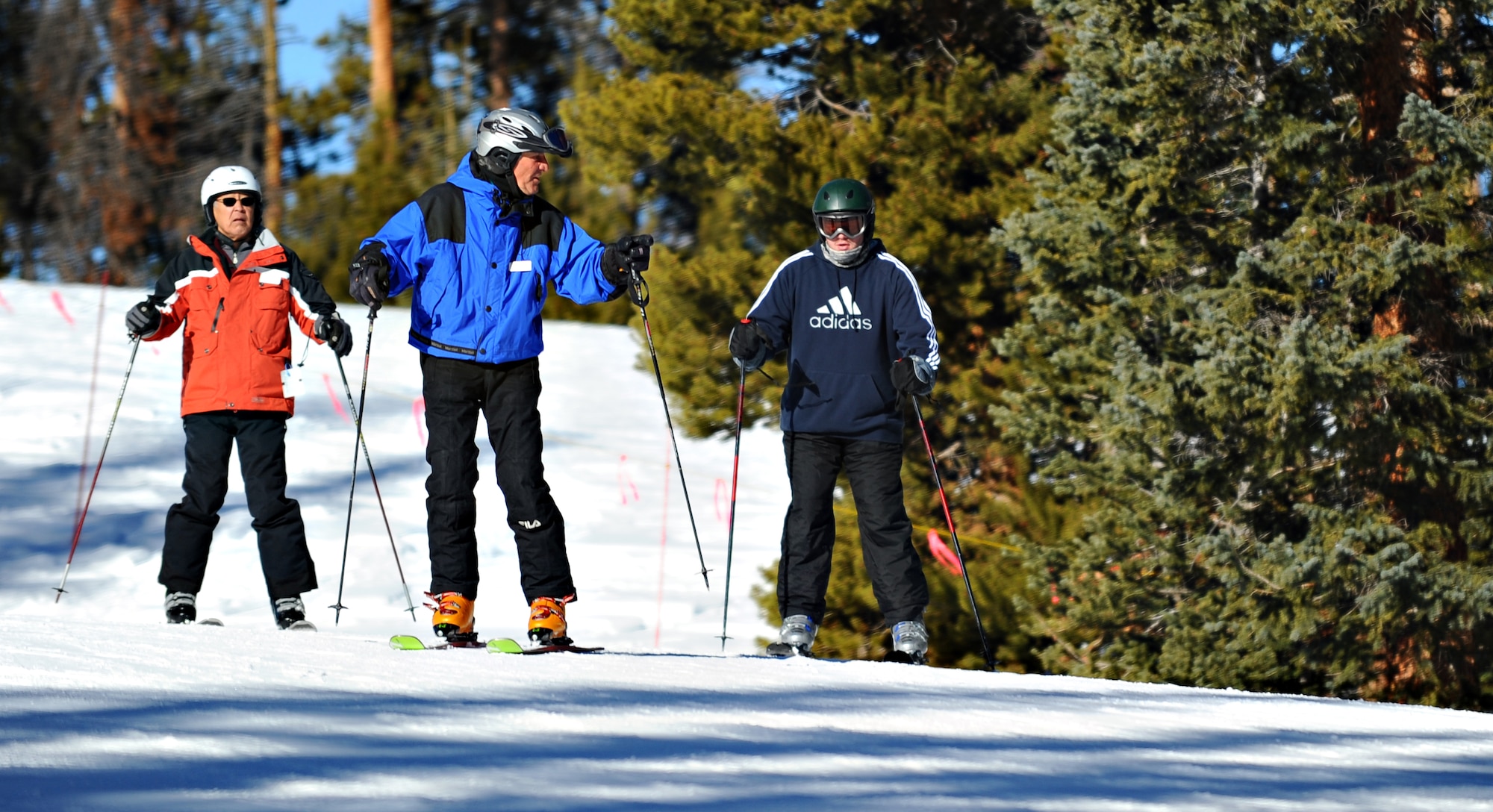 With the help of volunteer instructors from Keystone Adaptive Center, Army Specialist Mike Haugen (right) tries skiing for the first time in his life, despite his back injury. Adaptive Adventures funds trips for wounded warriors during SnoFest, affording injured servicemembers the opportunity to ski. (U.S. Air Force photo/Master Sgt. Christopher DeWitt)