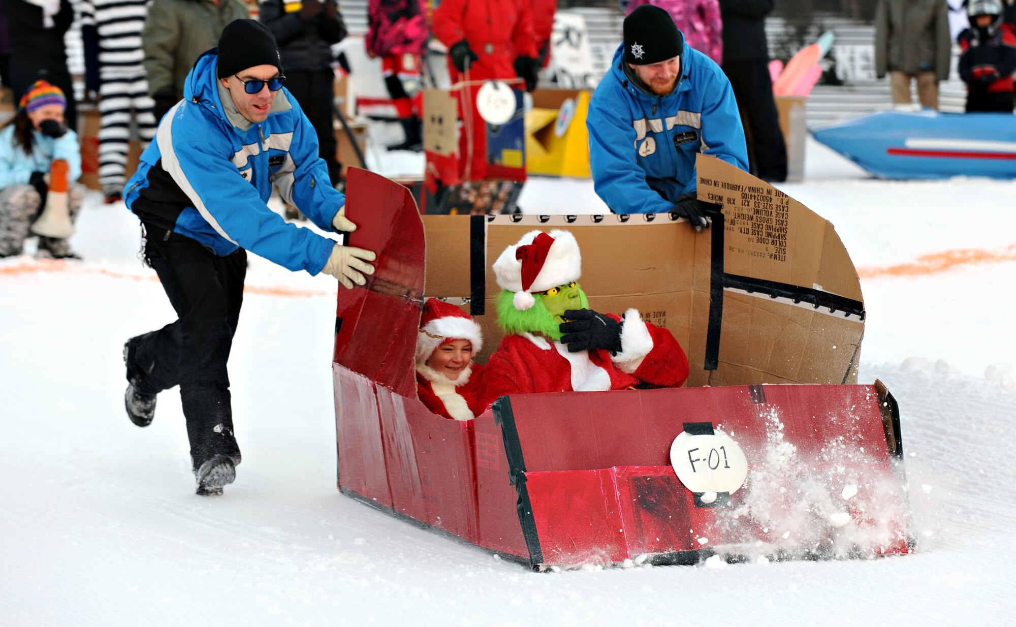 The Grinch takes a ride down the slopes at SnoFest during the Cardboard Derby Jan. 30, 2011. Twenty-four entries competed, earning points for most creative and crowd favorite during the cardboard derby races on the second day of SnoFest. (U.S. Air Force photo/Master Sgt. Chirstopher DeWitt)