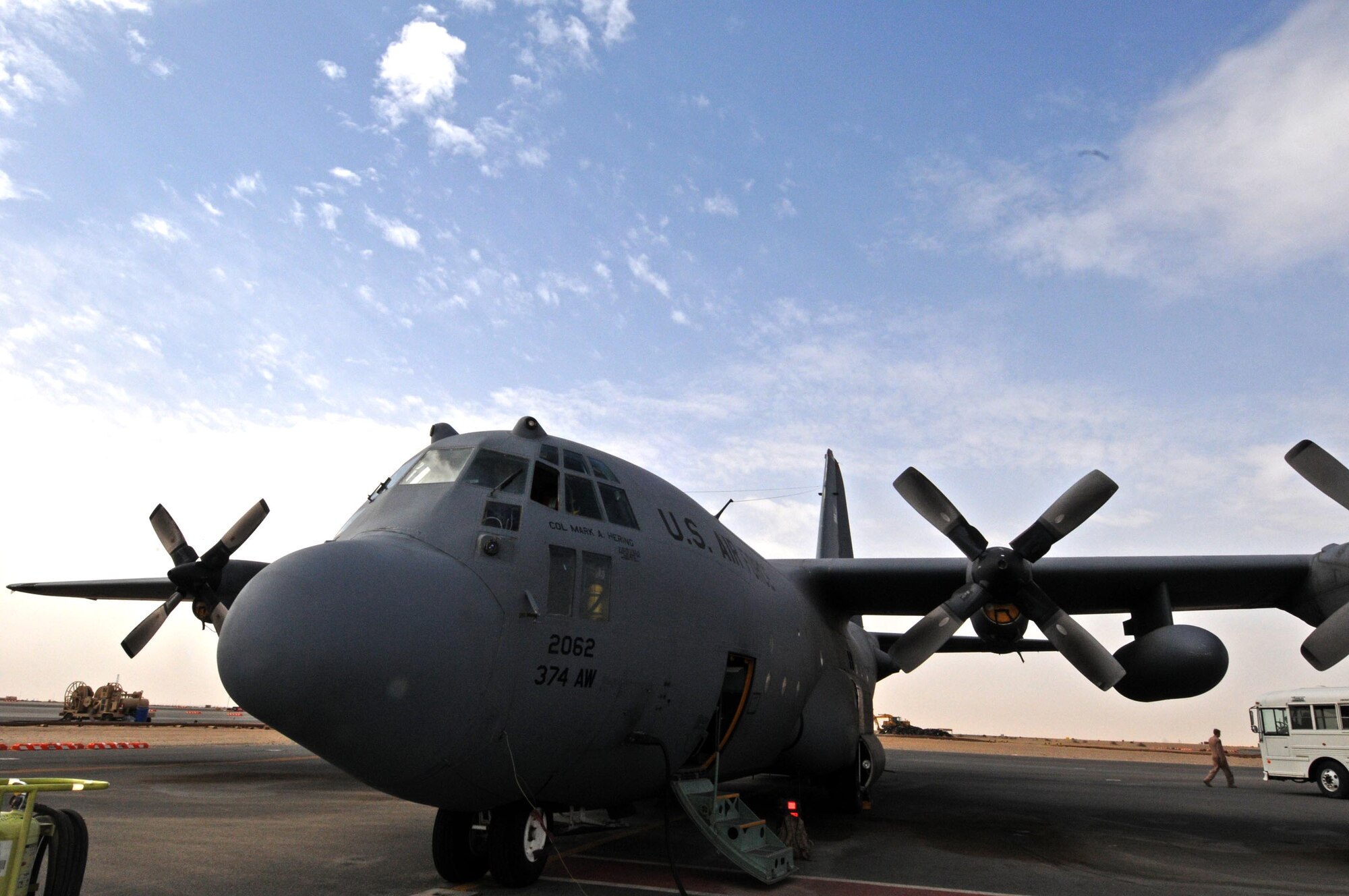 A C-130H Hercules sits on the ramp while Airmen from the 386th Air Expeditionary Wing tour inside it during the Quarry Open House here Feb. 2. Support function Airmen from the 386th AEW, also known as The Rock, were able to see the inner workings of the Quarry, or maintenance and operations side of the wing. (U.S. Air Force Photo by Staff Sgt. Patrice Clarke)