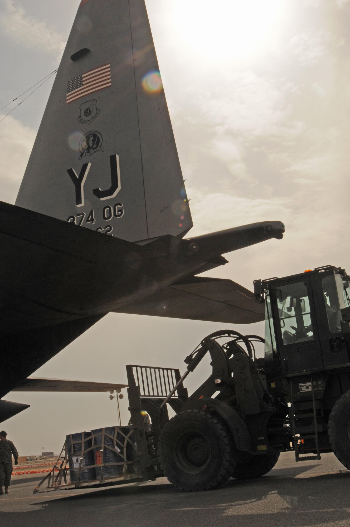 Aerial porters with the 386th Expeditionary Logistics Readiness Squadron load cargo onto the back of a C-130H Hercules as part of an aerial port demonstration during the Quarry Open House here Feb. 2. Airman from the 386th Air Expeditionary Wing were given a chance to experience what goes on at the Quarry or the flightline, side of operations. (U.S. Air Force Photo by Staff Sgt. Patrice Clarke)