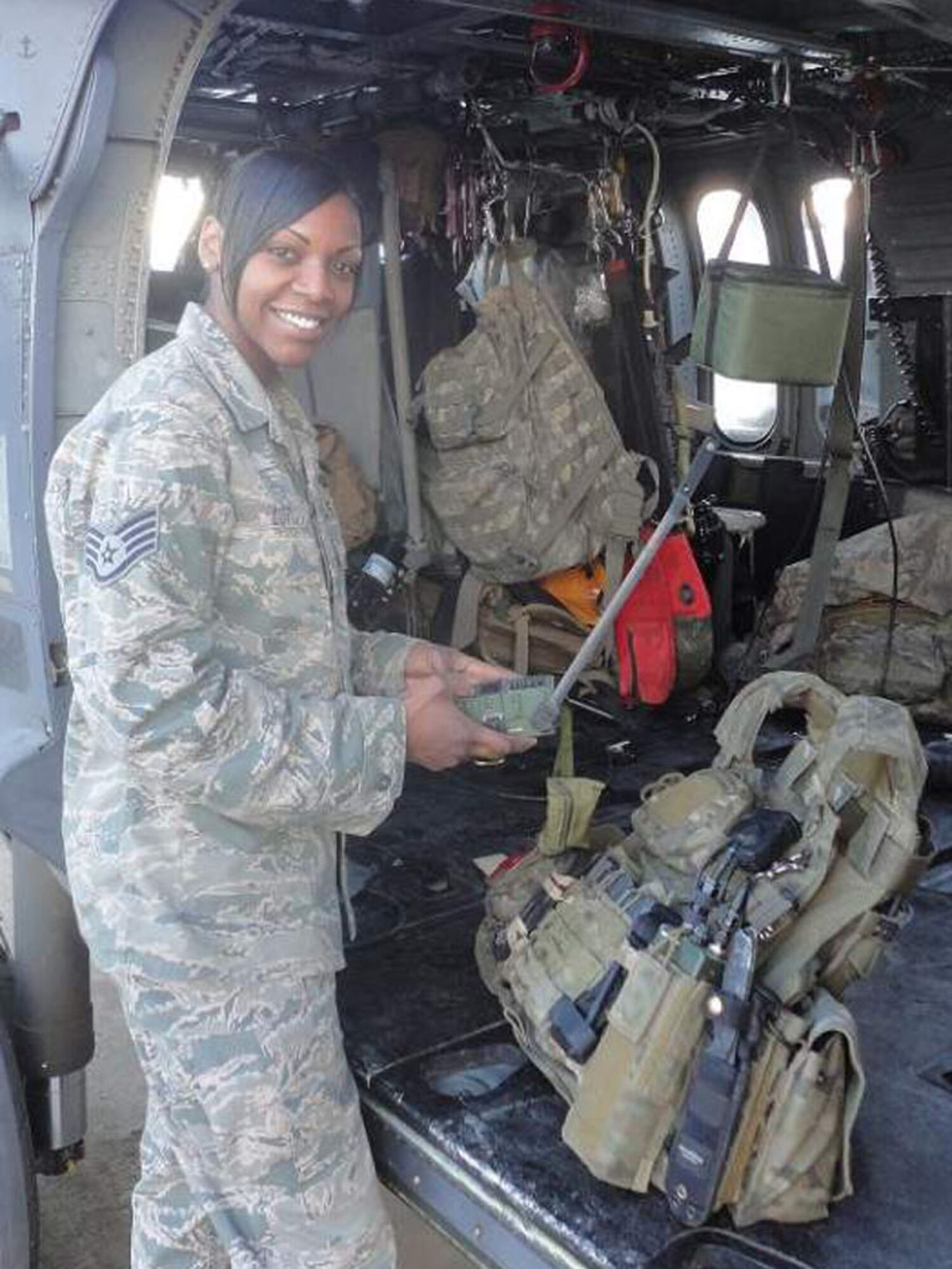 BAGRAM AIR BASE, Afghanistan -- Staff Sgt. Tiffany Lott, 56th Rescue Squadron aircrew flight equipment technician, prepares gear for a recent mission. Sergeant Lott was nominated for a Liberty Spotlight for exemplifying the core value of "Excellence in All We Do." (U.S. Air Force photo courtesy of Lt. Col. Steven Gregg)