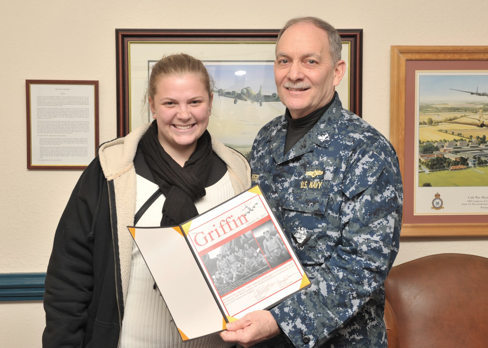 Navy Captain Gary S. Powers, Deputy Commander of the JIOCEUR Analytic Center at RAF Molesworth presents a special certificate to Ms. Theodora “Teddi” Gobrecht commemorating her January 25, 2011 visit to the wartime home of the 303rd Bomb Group (Heavy). (U.S. Air Force photo by Staff Sgt. Javier Cruz)
