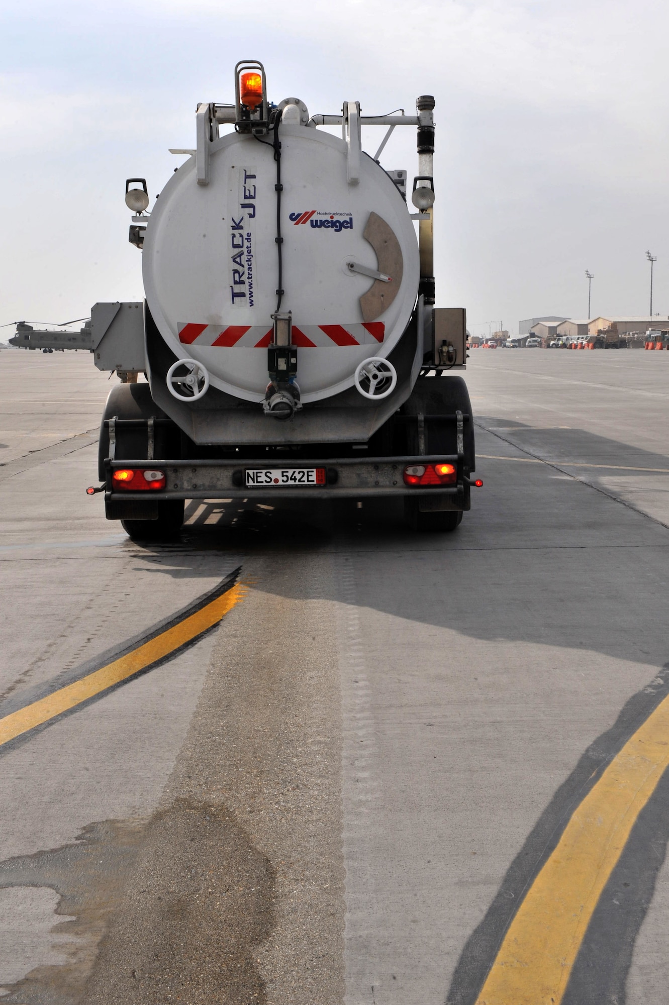 A TrackJet TJ-24 strips paint from the runway at Bagram Airfield, Afghanistan, Feb. 1, 2011. The EMTA company, headquartered in Turkey, has been awarded the contract to remove excess rubber from runway and repaint of more than 40 aircraft parking spaces here. (Air Force photo by Senior Airman Sheila deVera)