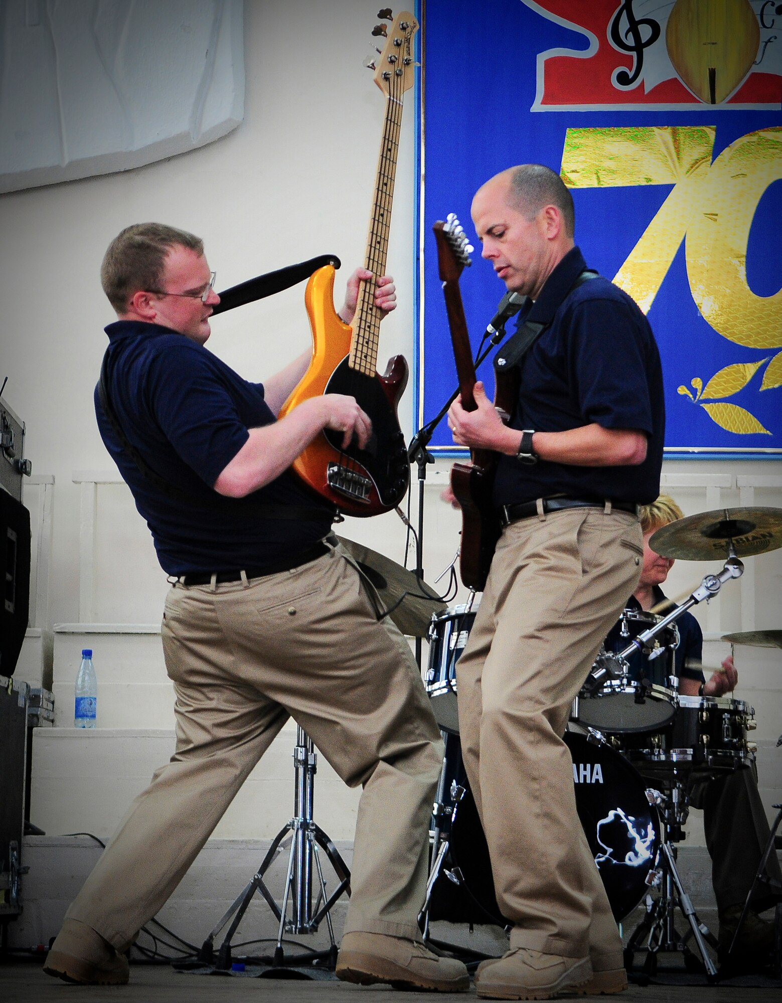 BISHKEK, Kyrgyzstan - Senior Airman  Brian Plank and Master Sgt. Jerry Kelley, U.S. Air Forces Central "Startlifter" band musicians, jam out during a performance at the Shubin Music School 29 Jan. The Starlifter band performed a wide variety of music for the for the Students and teachers to enjoy. (U.S. Air Force photo/Staff Sgt. Stacy Moless)