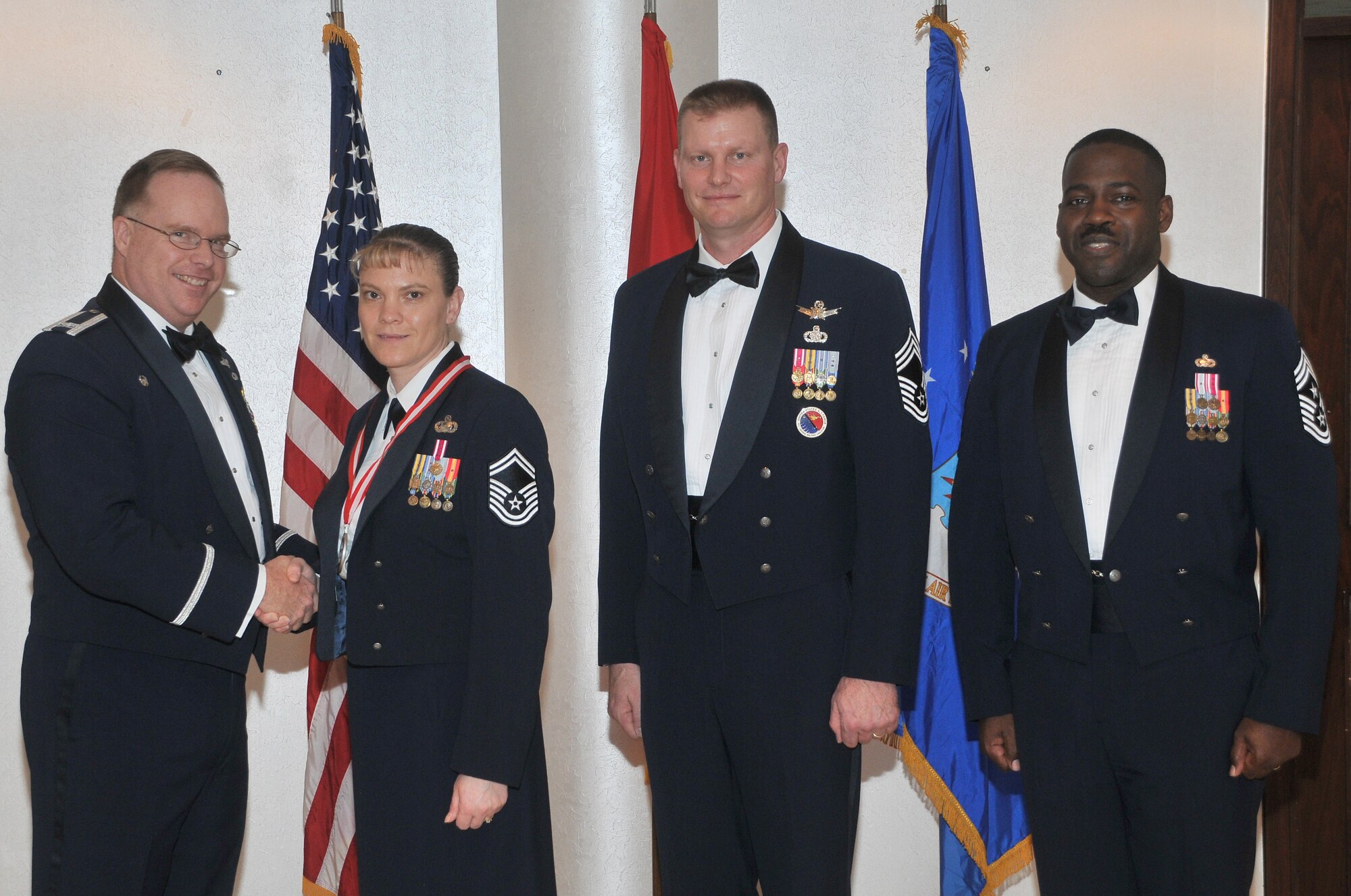 The 39th Air Base Wing Commander Col. Eric Beene presents the chief master sergeant medallion to Senior Master Sgt. Teresa Clapper, the 39th Force Support Squadron Manpower and Organization Section chief alongside Chief Master Sgt. David Lawrence, the commandant of the Kisling Noncommissioned Officer Academy and Chief Master Sgt. Marcus Snoddy, the 39 ABW command chief, before a chief master sergeant recognition ceremony Jan. 28, at Incirlik Air Base, Turkey.  (U.S. Air Force photo by Staff Sgt. Alexandre Montes/Released)