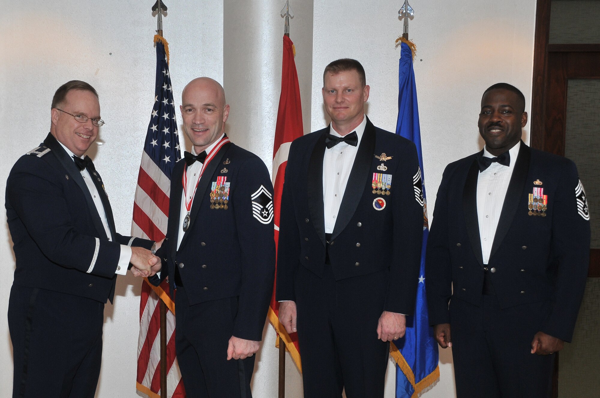 The 39th Air Base Wing Commander Col. Eric Beene presents the chief master sergeant medallion  to Senior Master Sgt. Brett Rodgers, the 39th Civil Engineer Squadron Explosive Ordinance Disposal Flight chief alongside Chief Master Sgt. David Lawrence, the commandant of the Kisling Noncommissioned Officer Academy and Chief Master Sgt. Marcus Snoddy, the 39th ABW command chief, before a chief master sergeant recognition ceremony Jan. 28, at Incirlik Air Base, Turkey.  (U.S. Air Force photo by Staff Sgt. Alexandre Montes/Released)