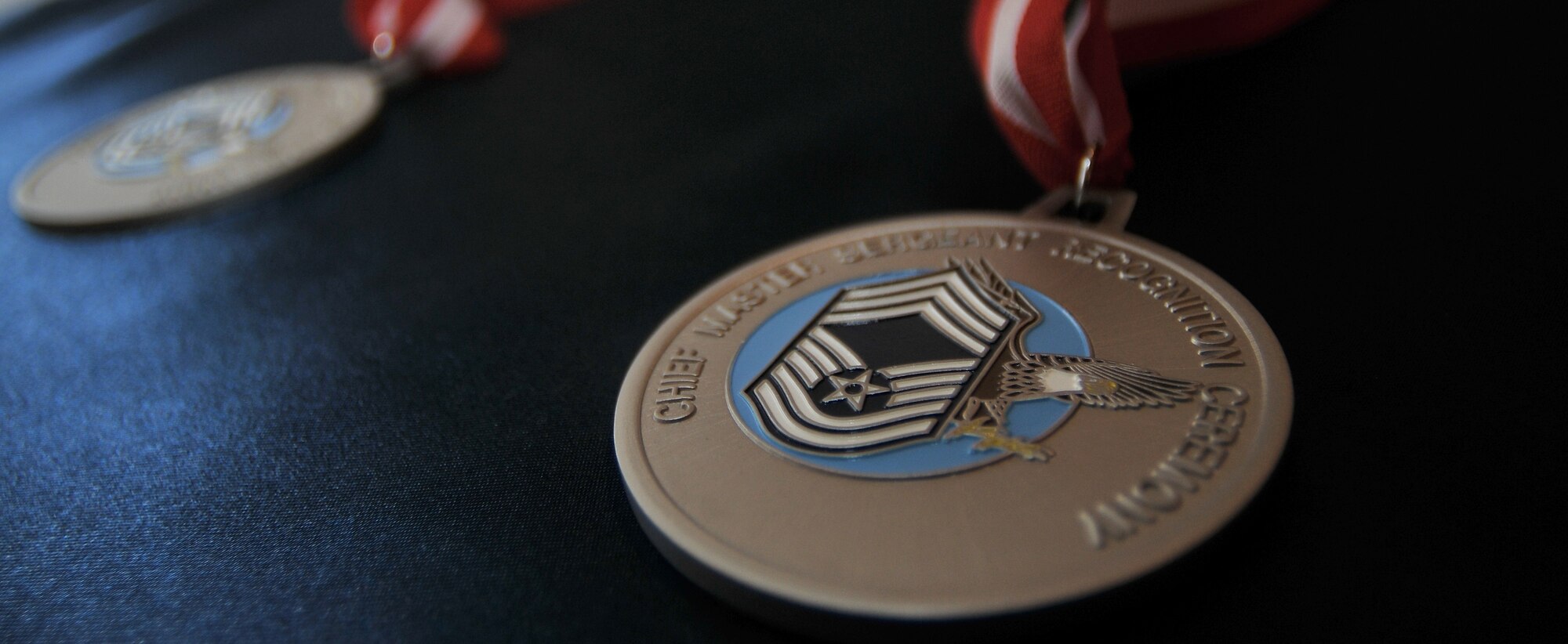 The chief master sergeant recognition ceremony is one of the oldest military traditions. In the late 1950s, the Air Force introduced a new super enlisted grade to replace its warrant officers. This top enlisted grade came to be called, “chief master sergeant.” The word “chief” means, “one who is highest in rank or authority.” The word “master” means, “a teacher or mentor.” The word “sergeant” refers to, “any of the noncommissioned officer ranks appointed to a rank conferring leadership.” The Air Force only promotes 1 percent of its enlisted force to the rank of chief master sergeant. (U.S. Air Force photo by Staff Sgt. Alexandre Montes/Released) 