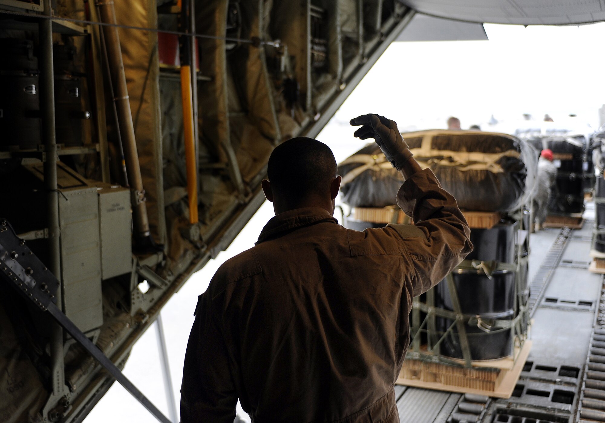 Tech. Sgt. Josh Romero loads a bundle of supplies for an airdrop mission Feb. 2, 2011, at Kandahar Airfield, Afghanistan. A parachute is attached to each bundle allowing 99 percent of the airdropped bundles to be recovered undamaged during the month of January. Sergeant Romero is a loadmaster assigned to the 772nd EAS. (U.S. Air Force photo/Senior Airman Willard E. Grande II/Released)