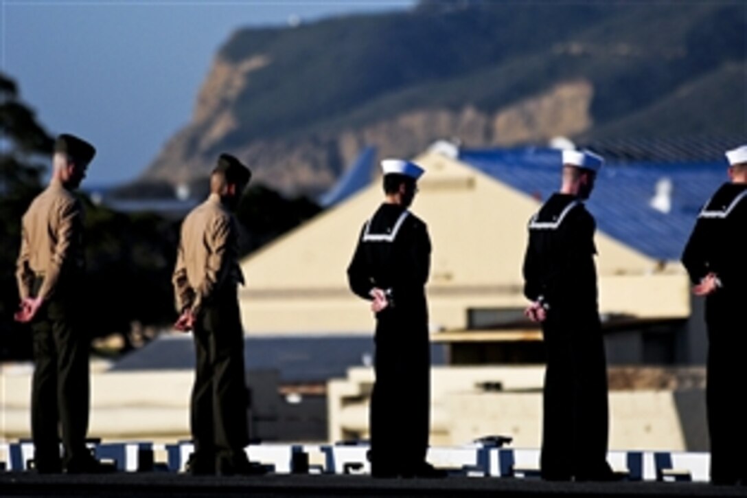 U.S. Navy sailors and Marines from the aircraft carrier USS Ronald Reagan and embarked Carrier Air Wing 14 man the rails as the ship departs San Diego, Feb. 2, 2011. Crews traditionally man the rails as they depart the harbor for extended periods at sea. The Ronald Reagan Strike Group is under way conducting Joint Task Force Exercises before a deployment to the western Pacific Ocean and Central Command areas of operation.