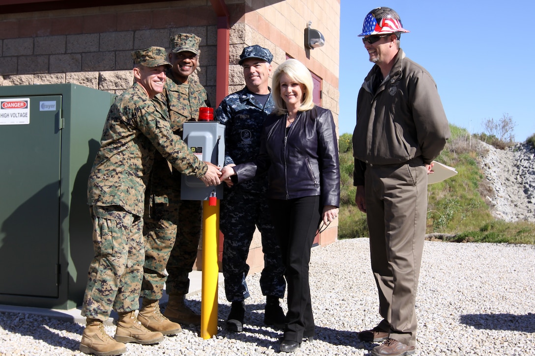 (Left to right) Col. Nicholas F. Marano, commanding officer, Marine Corps Base Camp Pendleton; Maj. Gen. Anthony L. Jackson, commanding general, Marine Corps Installations West; Navy Capt. Martin W. Smith, deputy commander, OICC MCI-W; Diane Keltner, president, Synergy Electric; Jeff Allen, energy manager, Assistant Chief of Staff Facilities; flip the ceremonial switch to fire up Marine Corps Installations West’s newest $9.4 million photovoltaic system, funded by the American Recovery and Reinvestment Act of 2009.