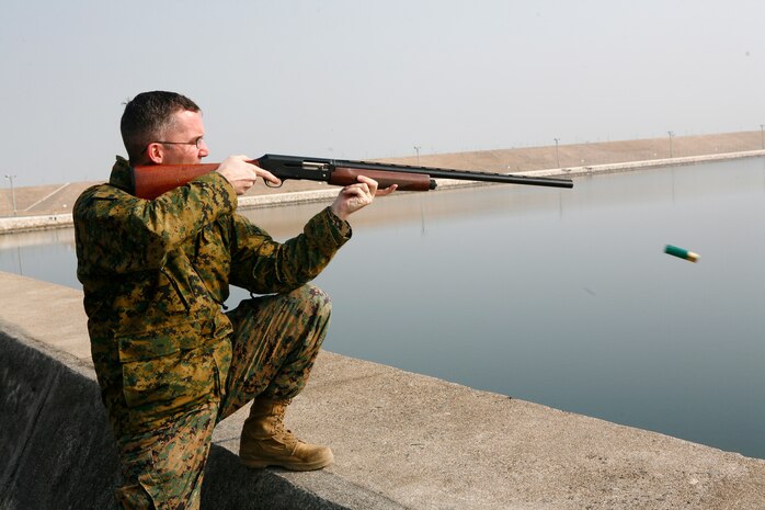 Gunnery Sgt. Shane Smoger, station Airfield Operations chief, fires a 12-gauge shotgun at a bird during a Bird/Animal Aircraft Strike Hazard depredation exercise near the airfield here Feb. 4. While always used as a last resort, lethal force is sometimes necessary to curb bird populations around the airfield. Depredating over water causes another set of concerns because the bird must be collected if at all possible. Leaving dead animals of any kind has the potential to attract more winged predators, which is counter-intuitive to the BASH program’s goals.