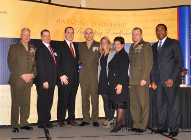 General James F. Amos, Commandant of the Marine Corps, stands with 2010 Manion Award recipient Capt. Miguel Cruz, Marine Wing Support Squadron 171 maintenance management officer and S-2 intelligence officer, Lt. Gen. Frank A. Panter, Marine Corps deputy commandant for installations and logistics, and the Manion family during the 7th annual MCA Ground Logistics Awards dinner in Arlington, Va. Feb. 3.