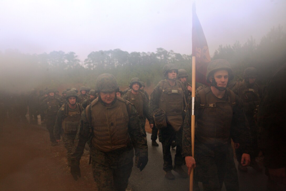 Corporal Willie Alvarado, a chemical, biological, radiological, and nuclear defense specialist for Headquarters Battalion, 2nd Marine Division, catches his breath while on a five mile hike aboard Marine Corps Base Camp Lejeune, N.C., Feb. 6, 2011.  After the hike, the Marines finished with a two mile run. The physical training was meant to increase unit cohesion and combat fitness. (Official U.S. Marine Corps photo by Lance Cpl. Walter D. Marino II)