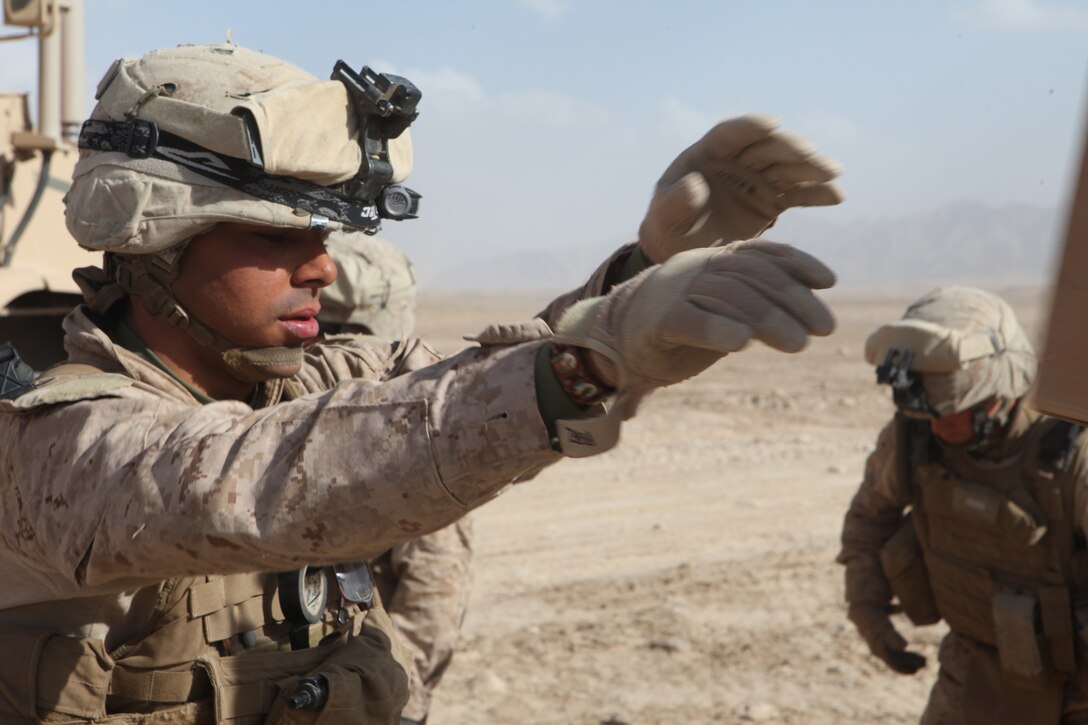U.S. Marine Corps Lance Cpl. Joseph A. Perez, a mortorman with Weapons Platoon, Company L, Battalion Landing Team 3/8, 26th Marine Expeditionary Unit, Regimental Combat Team 2, throws a box of Meals Ready to Eat to another Marine during a resupply to their patrol base near Combat Outpost Ouellette in the Helmand province, Afghanistan, Feb. 04, 2011. Elements of the 26th Marine Expeditionary Unit deployed to Afghanistan to provide regional security in Helmand province in support of the International Security Assistance Force.