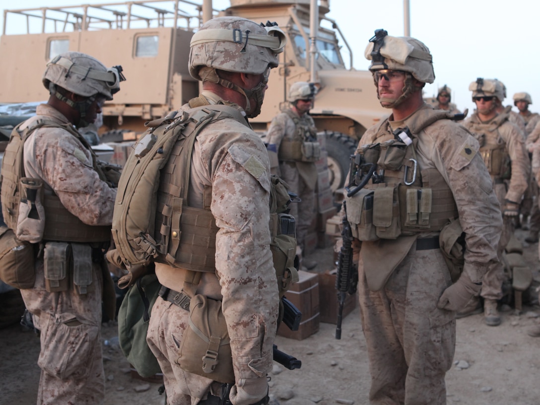 U.S. Marine Corps 1st Sgt. Troy A. Nicks, 1st Sgt. for Company L, Battalion Landing Team 3/8, 26th Marine Expeditionary Unit, Regimental Combat Team 2, reads the promotion warrant of U.S. Marine Corps Staff Sgt. Anthony A. Joens, a vehicle commander with Quick Response Force, during a promotion ceremony held near Combat Outpost Ouellette in the Helmand province, Afghanistan, Feb. 4, 2011. Elements of the 26th Marine Expeditionary Unit deployed to Afghanistan to provide regional security in Helmand province in support of the International Security Assistance Force.