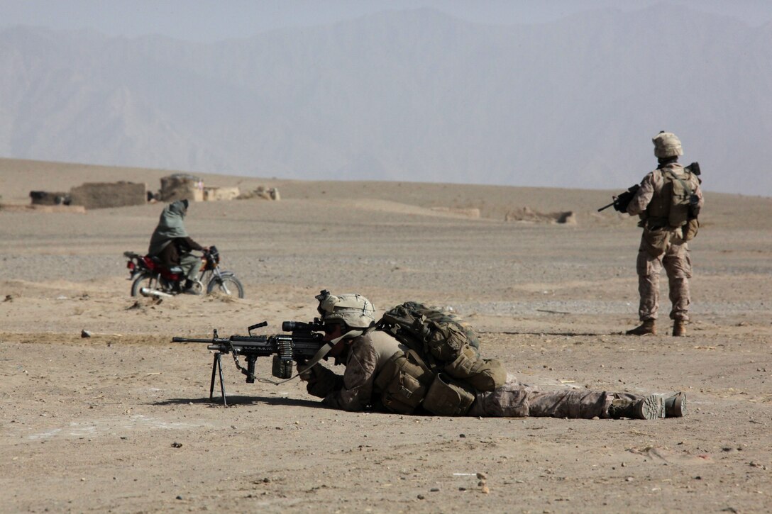 U.S. Marine Corps Lance Cpl. Joshua Hutchinson and Cpl. Anthony Arthur, both with 1st Platoon, Company I, Battalion Landing Team 3/8, 26th Marine Expeditionary Unit, Regimental Combat Team 2, establish security during a patrol near Turah Shah Ghundey, Helmand province, Afghanistan, Feb. 4, 2011. Elements of 26th Marine Expeditionary Unit deployed to Afghanistan to provide regional security in Helmand province in support of the International Security Assistance Force.